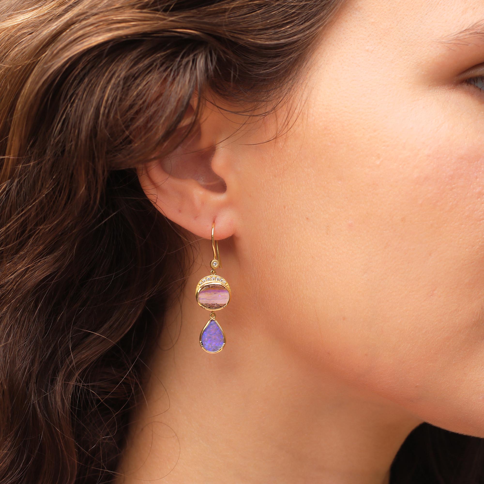 Model wearing Handmade one of a kind 18k gold Wood Opal earrings with sparkling White Diamond pave and diamond ear loop. Fine jewelry hand made in London.