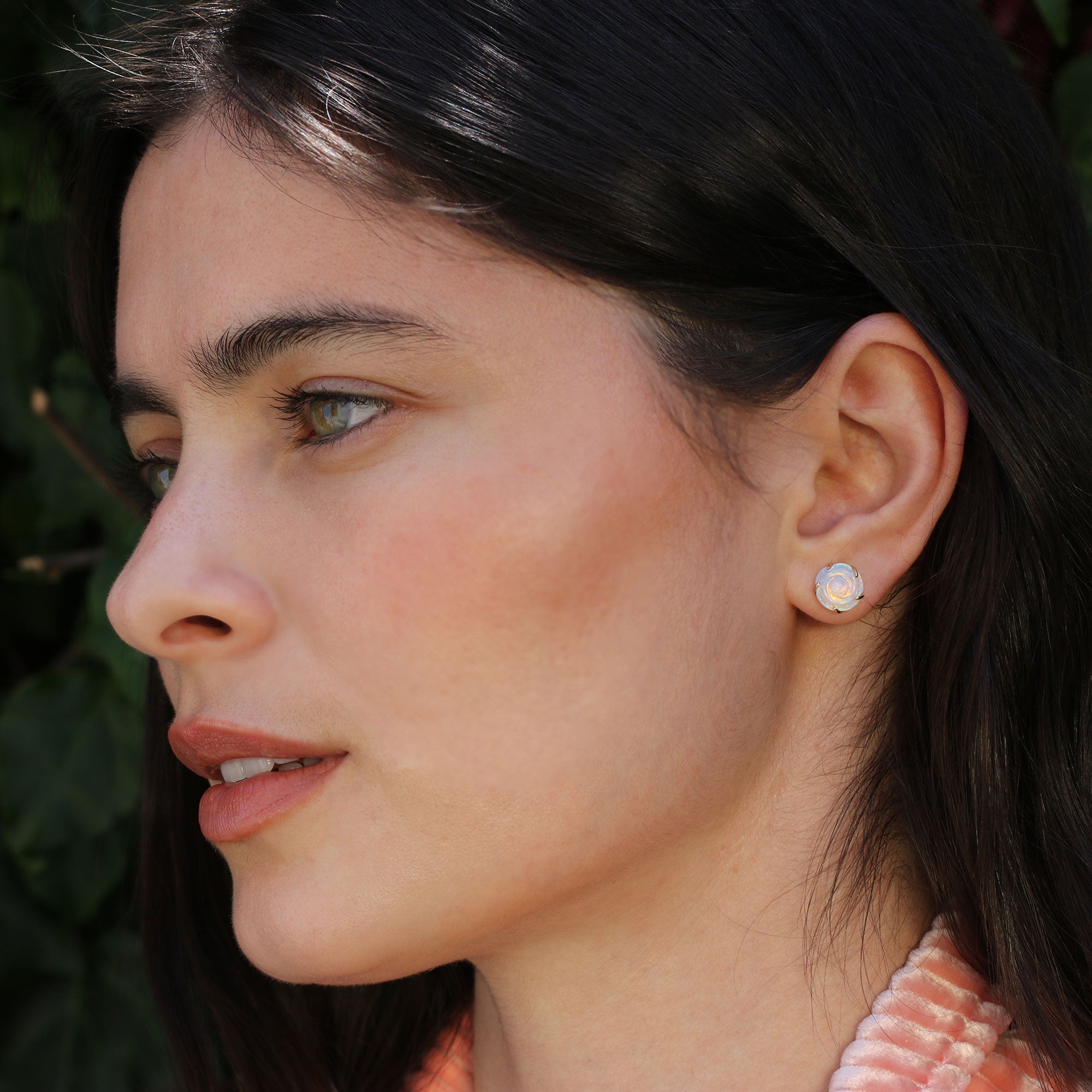 Model wearing one of a kind 18k gold earrings with hand carved opal flower from Los Angeles jewelry designer Brooke Gregson.