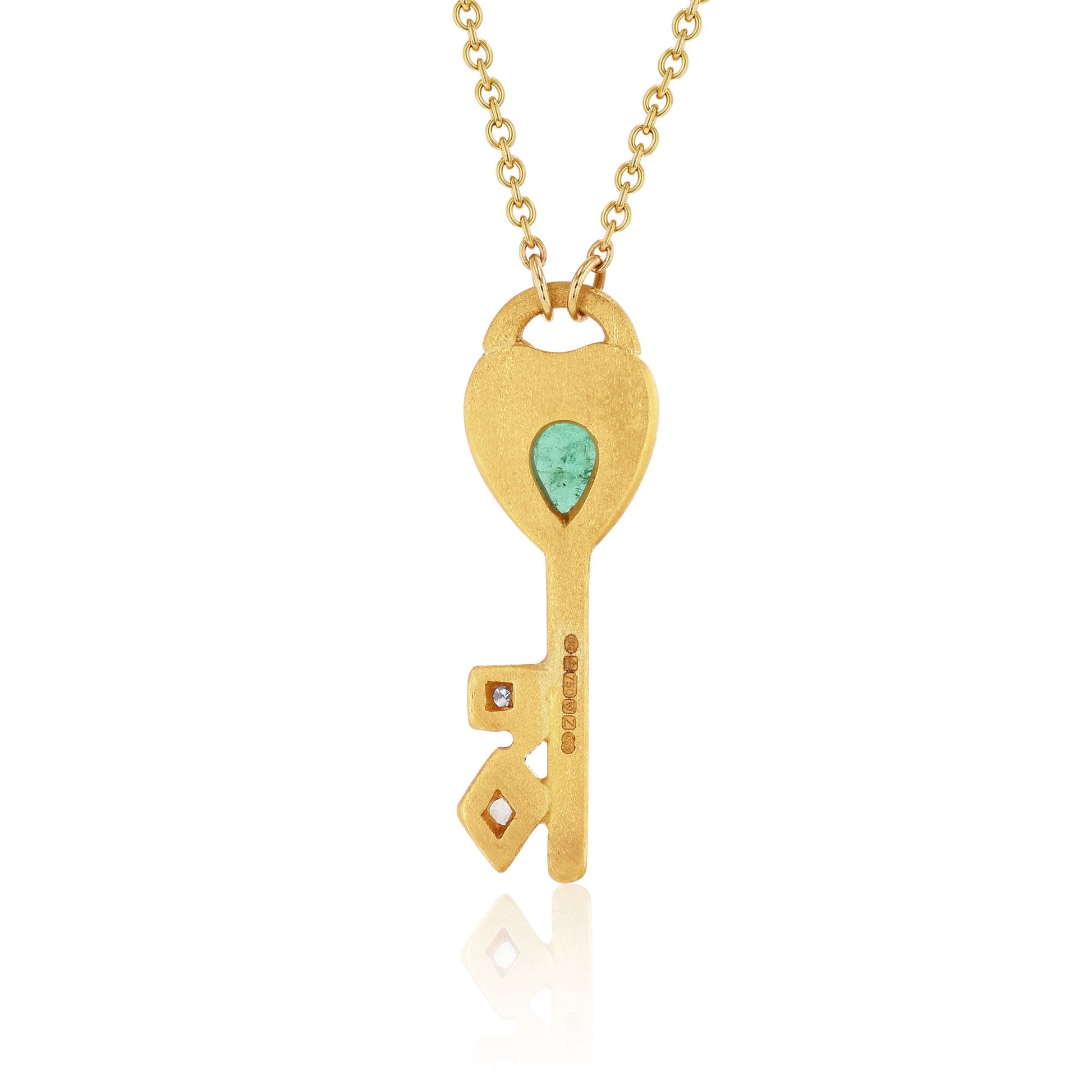 Back view one of a kind 18k gold necklace with a key-shaped pendant featuring hand engraved design, emerald, and white diamond pave detail from Los Angeles designer Brooke Gregson
