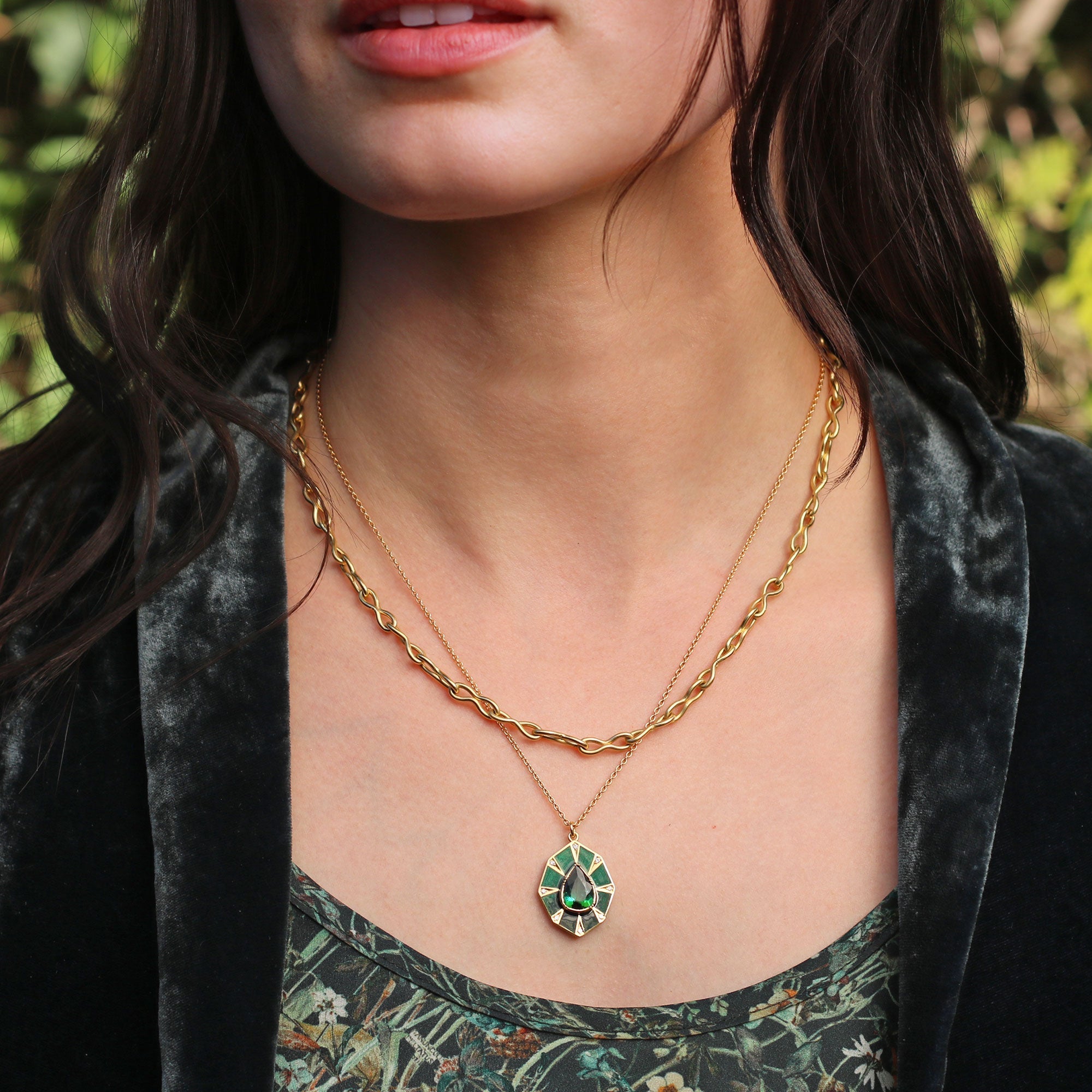 Model wearing one of a kind 18k gold necklace with teardop green tourmaline, enamel and diamond pave from Los Angeles jewelry designer Brooke Gregson