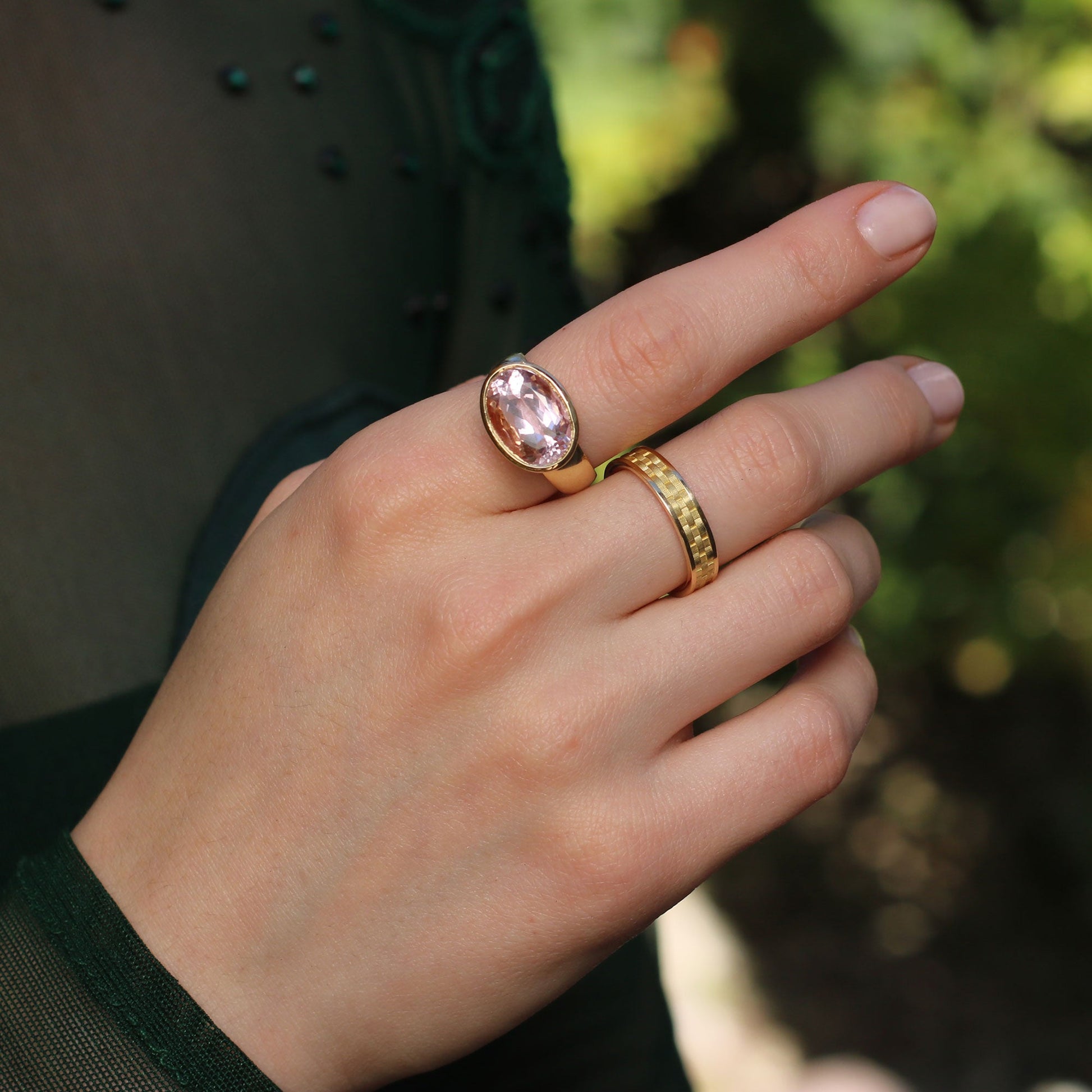 Model wearing 18k gold rings,  kunzite ring with basket weave engraved setting and basket weave band ring from Los Angeles jewelry designer Brooke Gregson