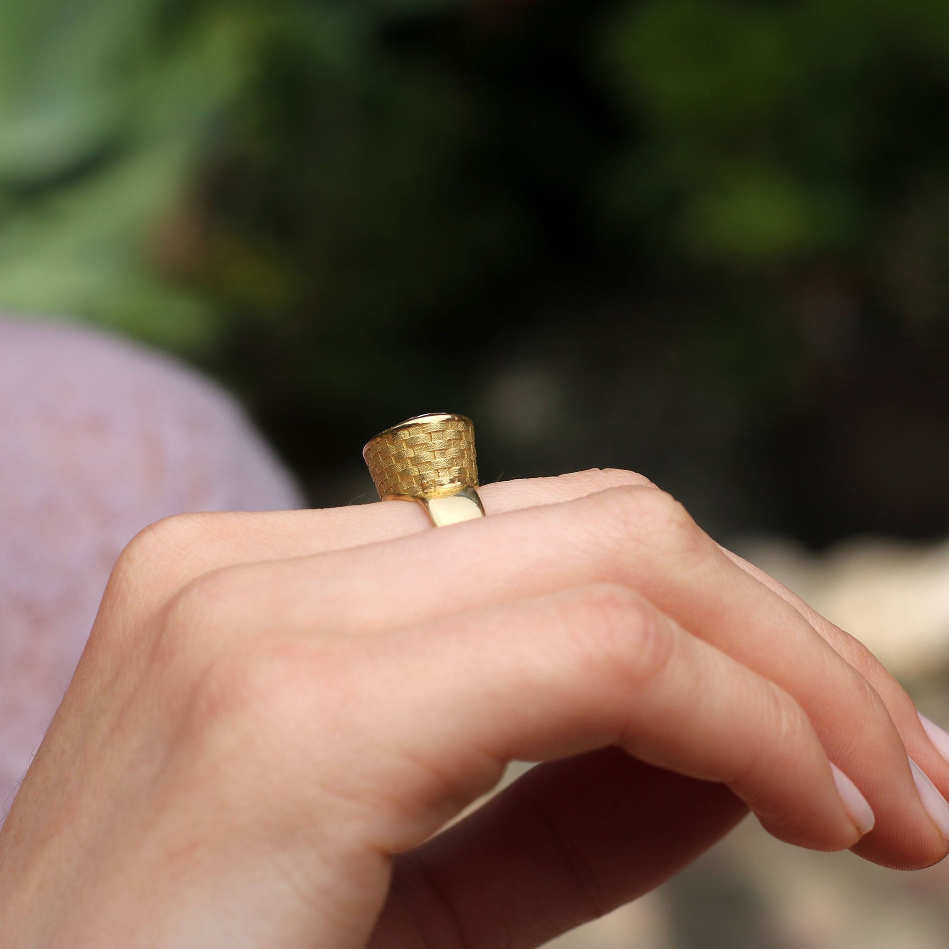 Side view of model wearing one of a kind 18k gold kunzite ring with basket weave engraved setting and brushed gold band from Los Angeles jewelry designer Brooke Gregson