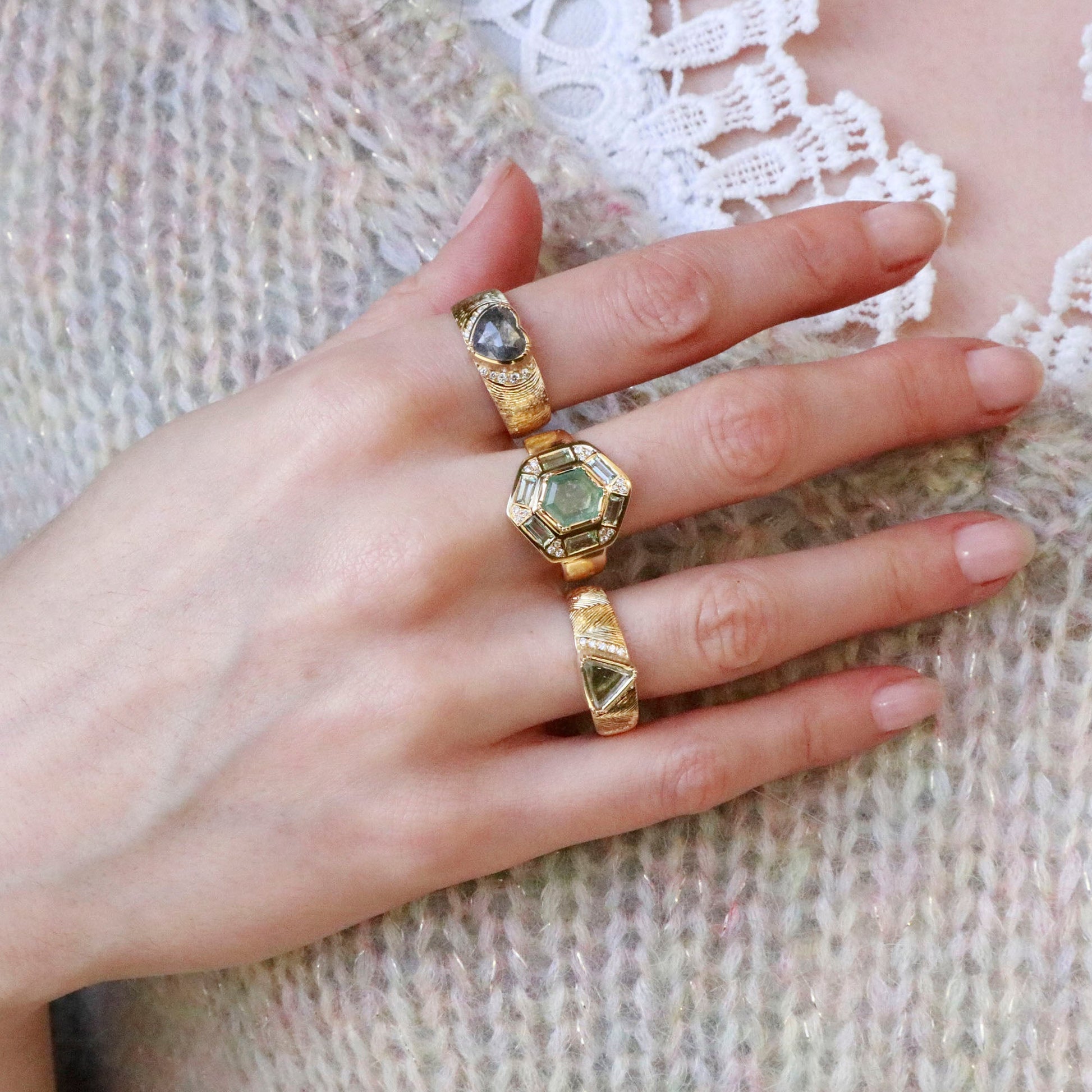 Model wearing multiple one of a kind 18k gold diamond rings from Los Angeles fine jewelry designer Brooke Gregson
