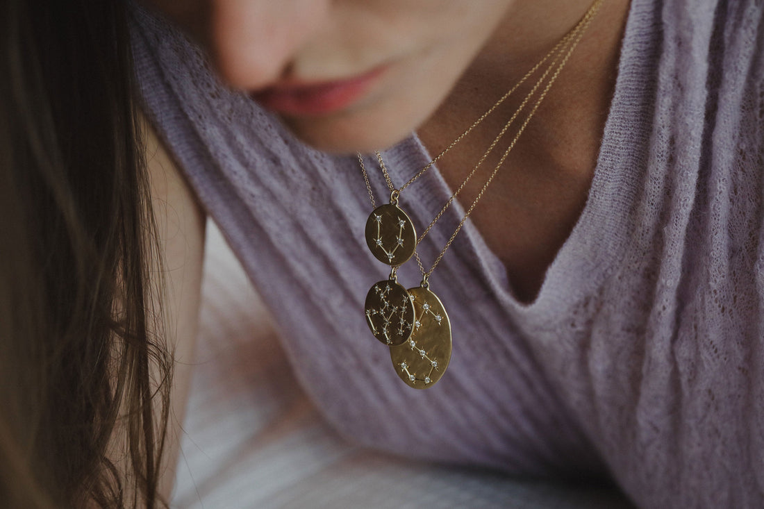 Model wearing Astrology zodiac necklaces in 14k gold with diamonds from Los Angeles designer Brooke Gregson