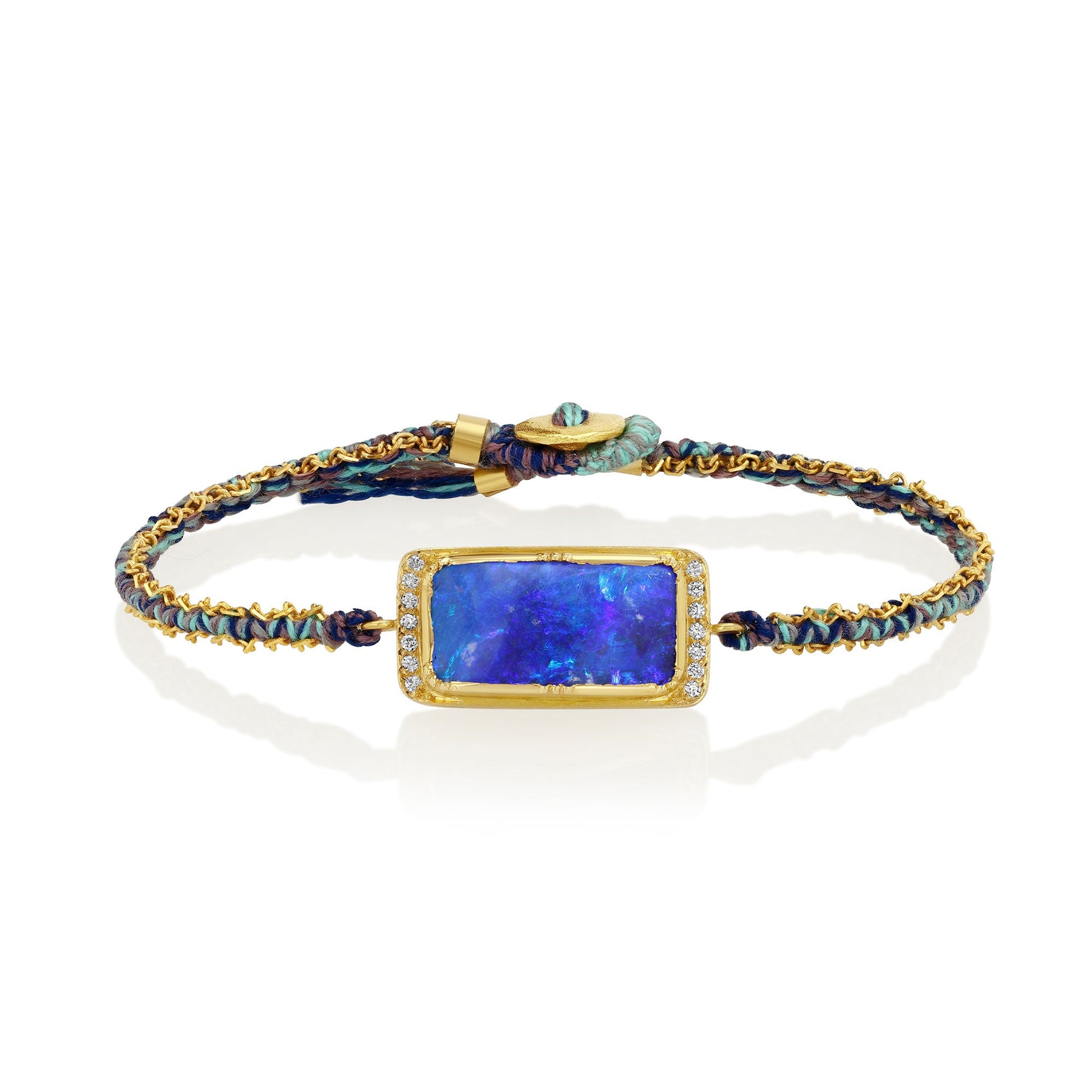Silk bracelet with blue boulder opal stone and gold chain on a white background