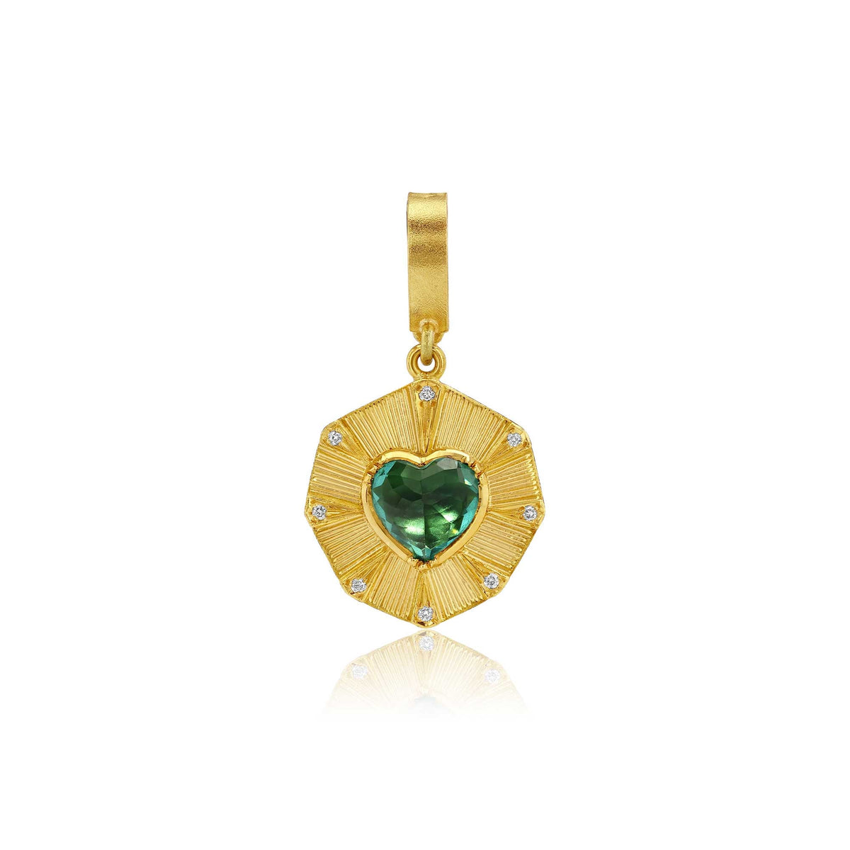 A gold pendant featuring a textured sunburst design with a central green heart-shaped tourmaline gemstone and small clear diamond stones, shown on a white background with a soft reflection.