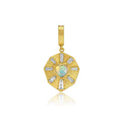 A gold pendant featuring a central heart-shaped opal surrounded by baguette-cut clear diamond stones in a sunburst design, set against a plain white background with a soft reflection below.