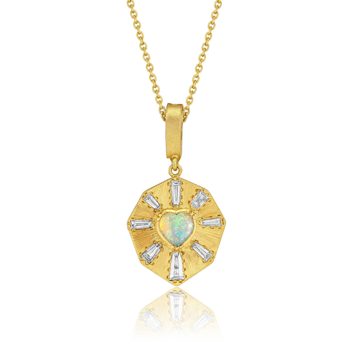 An 18k gold pendant necklace featuring a central heart-shaped opal and surrounding baguette-cut diamond stones with hand engraved rays, suspended on a simple round cut chain against a white background. Designed by Brooke Gregson jewelry designer.