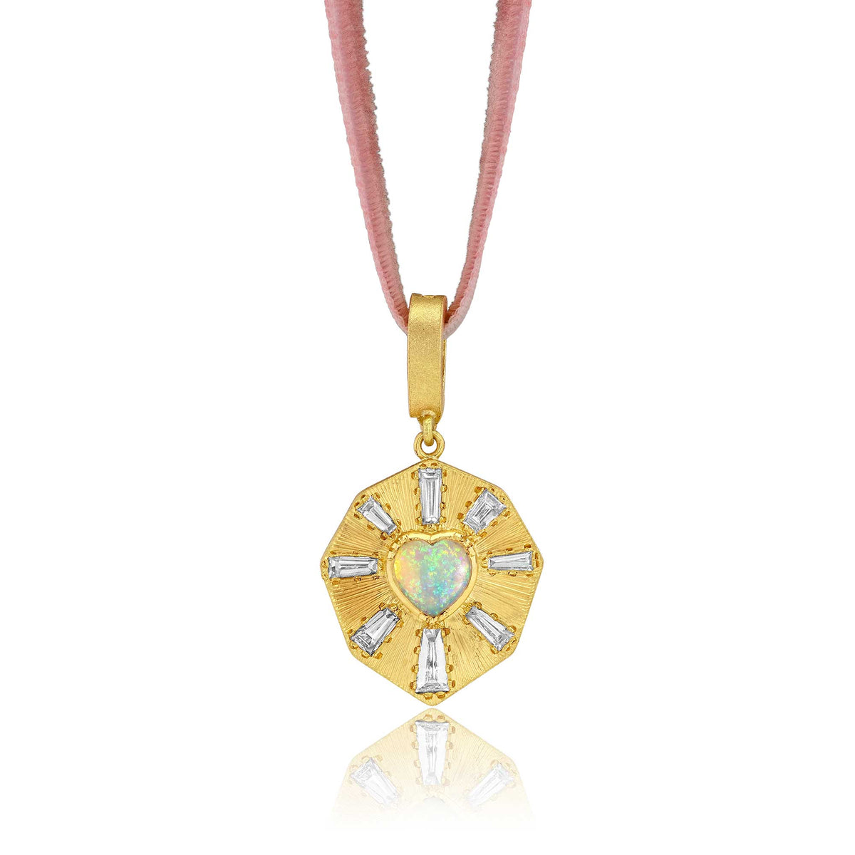 An 18k gold pendant necklace featuring a central heart-shaped opal and surrounding baguette-cut diamond stones with hand engraved rays, suspended on a pink mauve adjustable velvet cord against a white background. Designed by Brooke Gregson jewelry designe