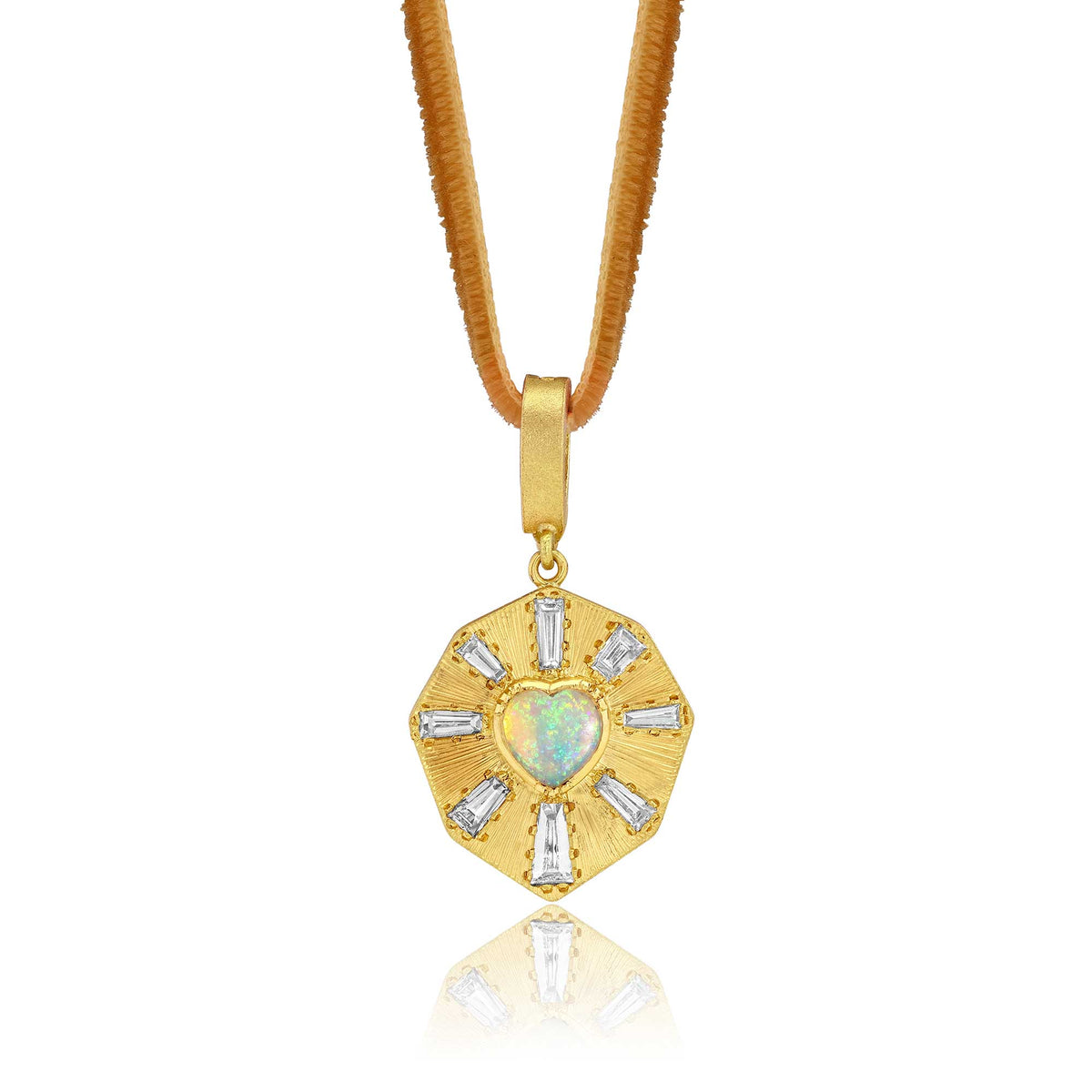 An 18k gold pendant necklace featuring a central heart-shaped opal and surrounding baguette-cut diamond stones with hand engraved rays, suspended on a sand adjustable velvet cord against a white background. Designed by Brooke Gregson jewelry designer.