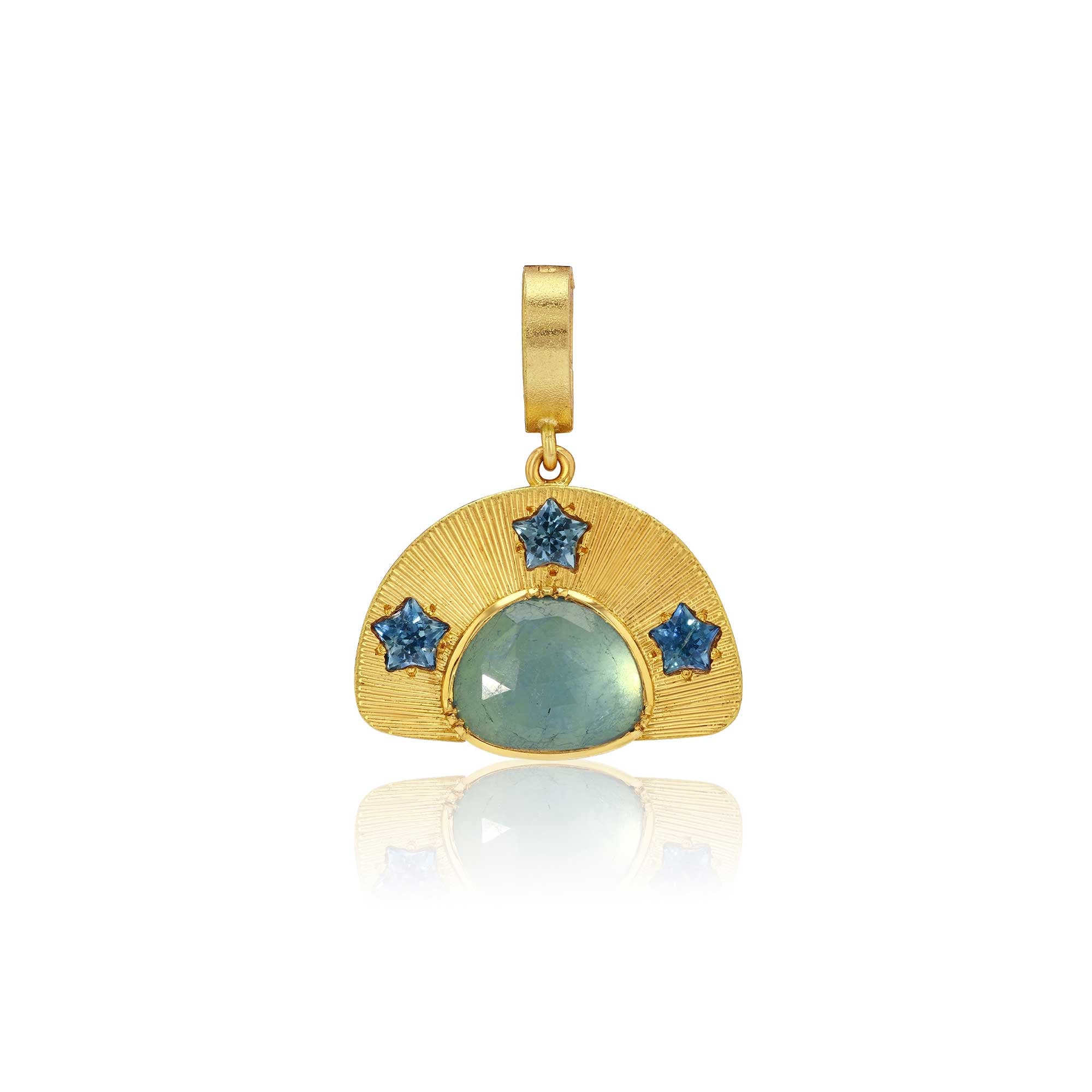 A gold pendant featuring a semi-circular sunburst design with a central round light blue aquamarine stone and three smaller star-shaped blue sapphire stones, shown on a white background with a soft reflection below.