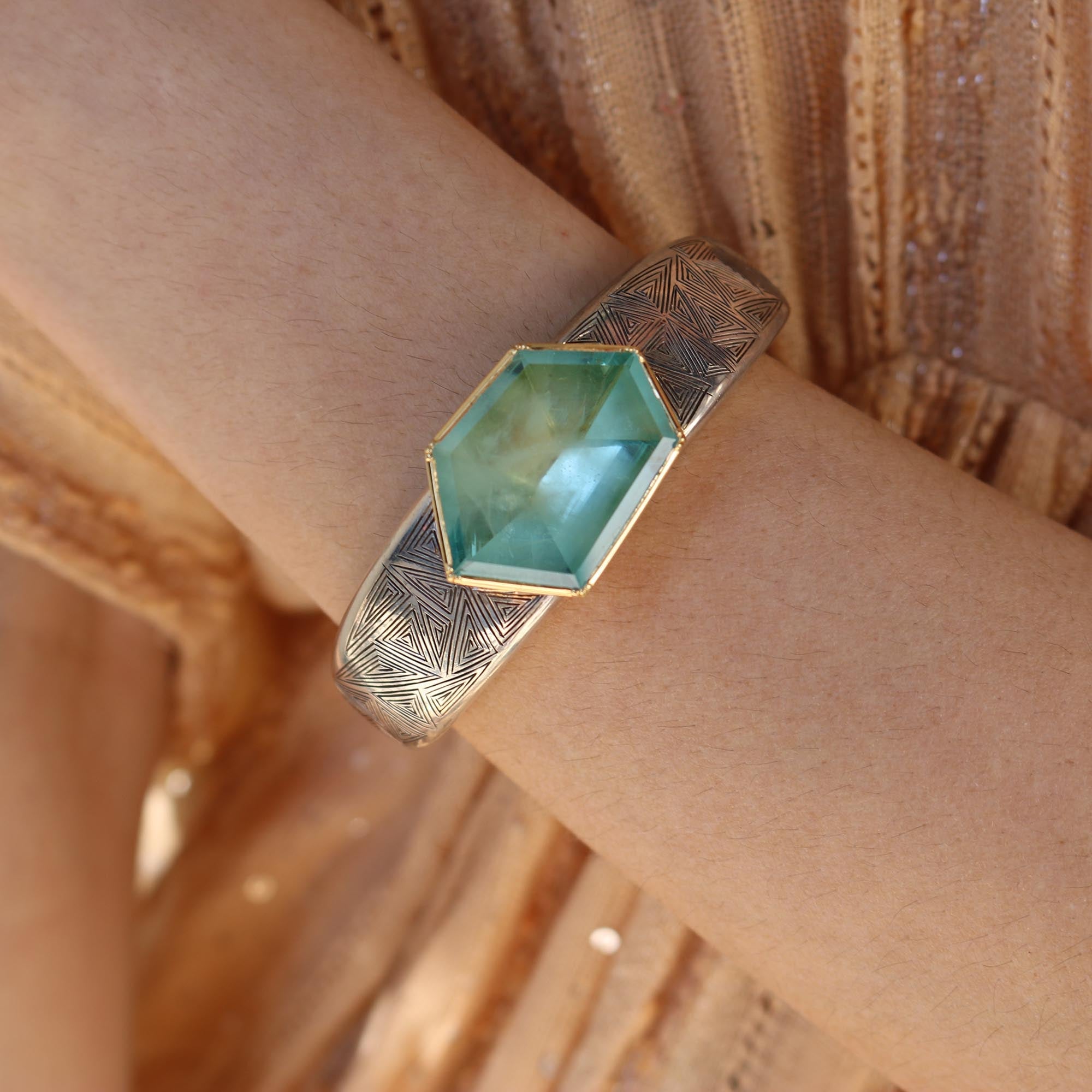 Model wearing One of a kind hand engraved silver cuff with 18k gold set Aquamarine by Los Angeles designer Brooke Gregson handmade in London.