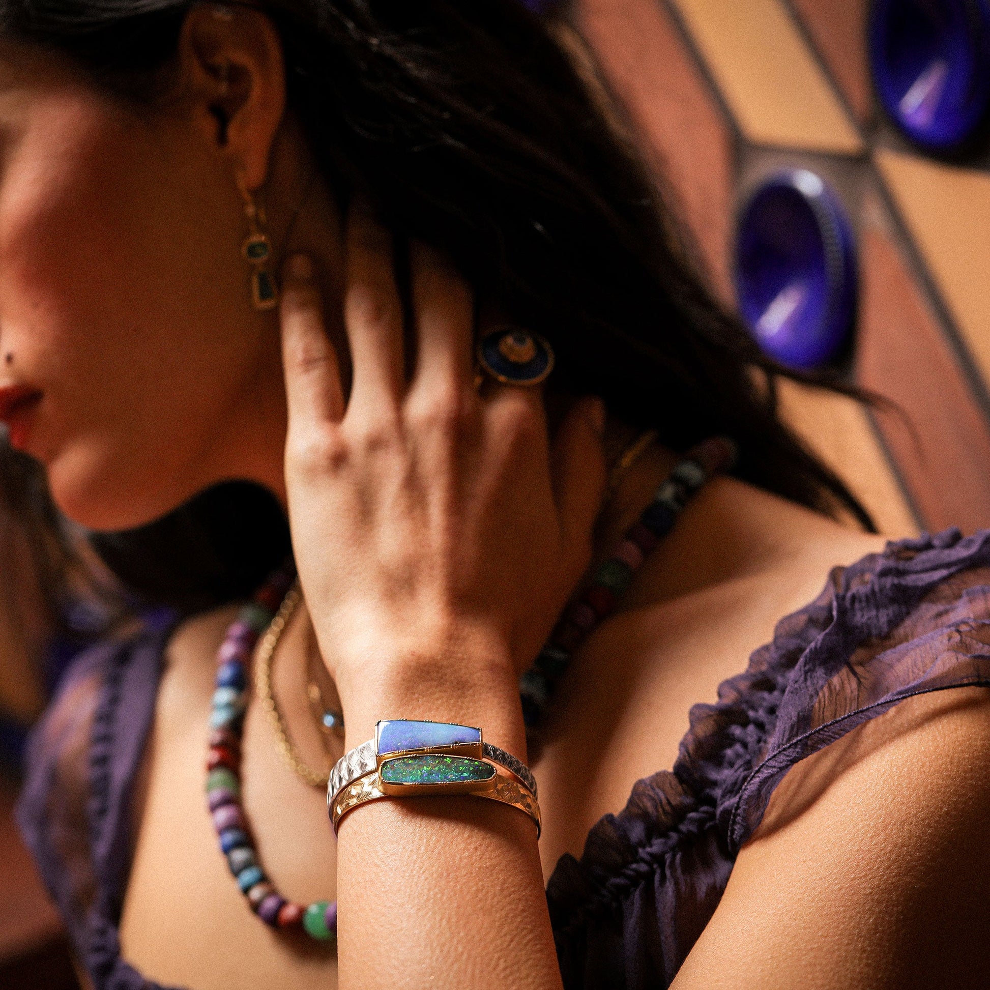 Woman wearing jewelry with a stained glass background