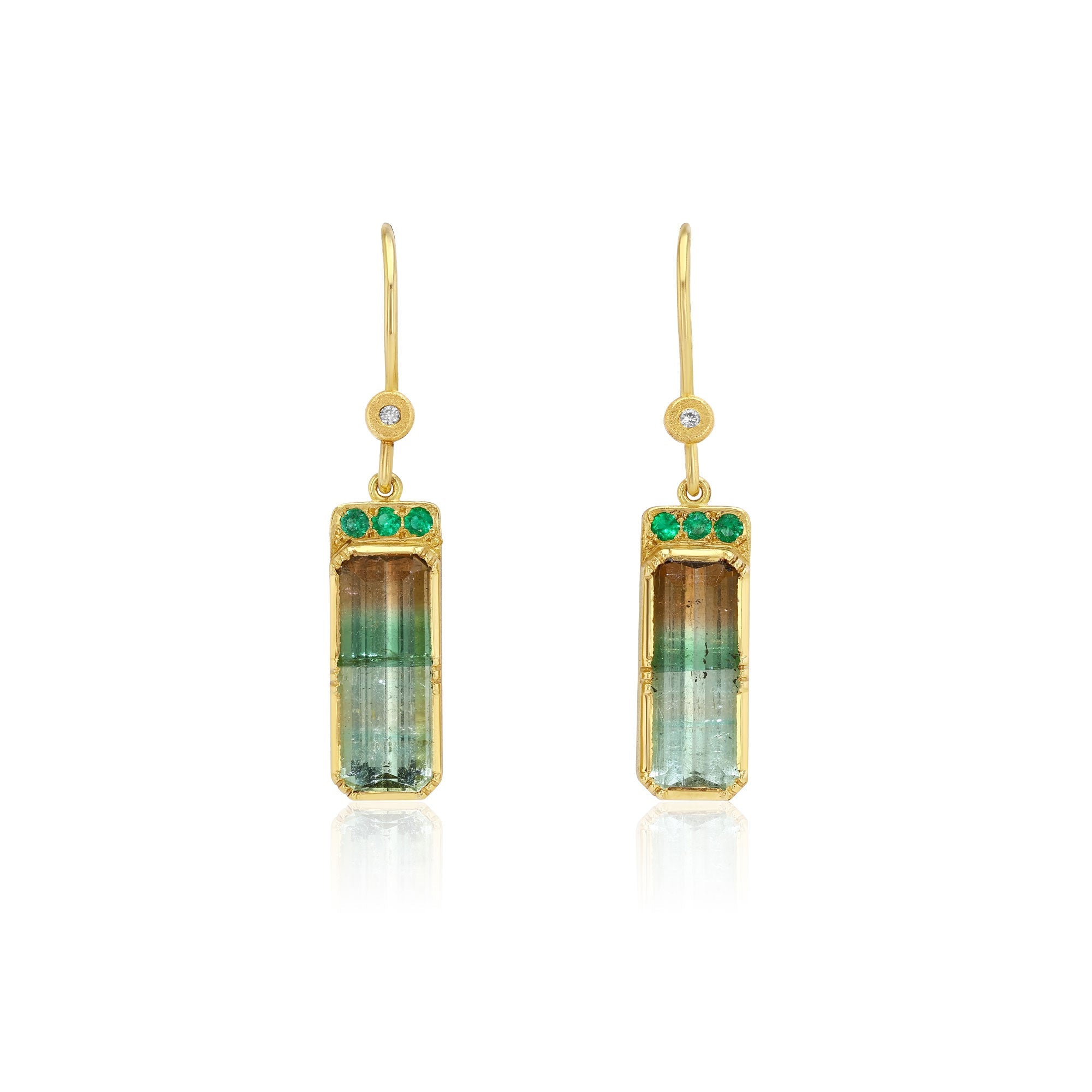 A pair of gold drop earrings featuring rectangular green and brown gradient tricolor tourmalines, accented with three small green emerald stones on each earring, set against a plain white background.