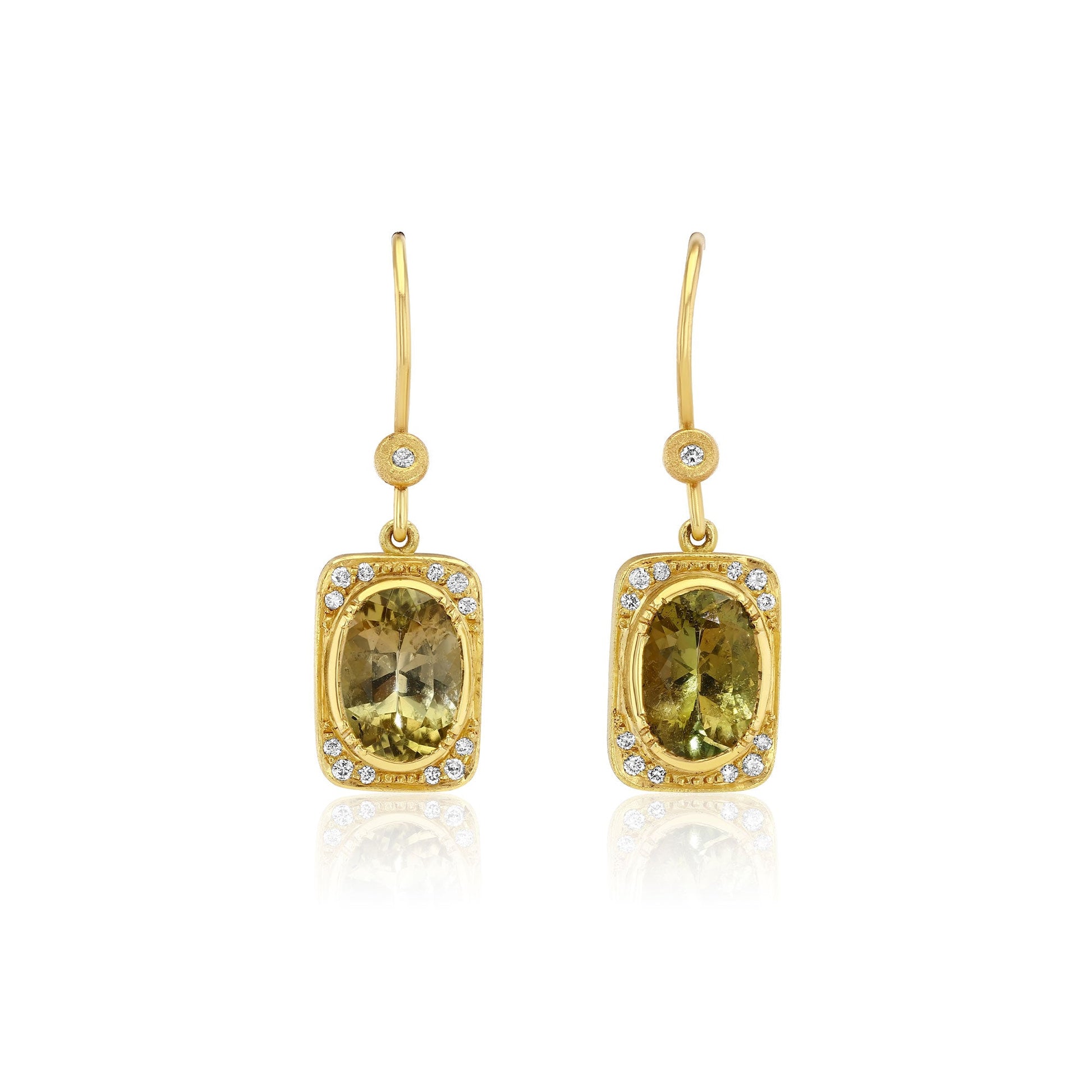 A pair of gold drop earrings featuring rectangular yellow-green tourmline gemstones surrounded by small diamond stones, shown on a clean white background with a soft reflection below.