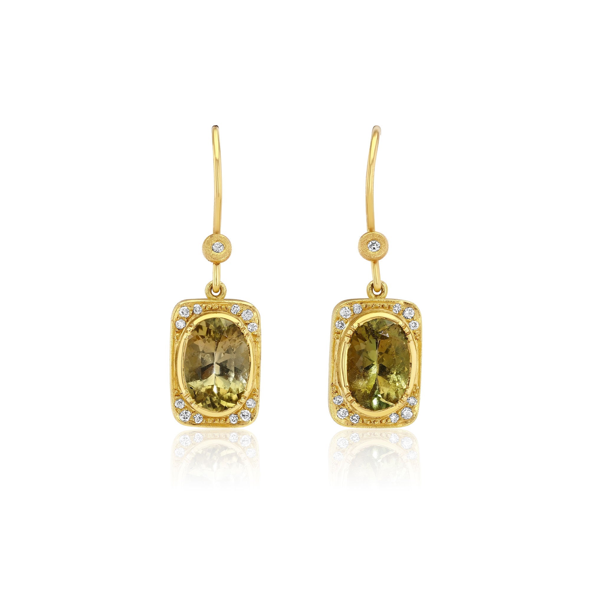A pair of gold drop earrings featuring rectangular yellow-green tourmline gemstones surrounded by small diamond stones, shown on a clean white background with a soft reflection below.