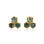 Hexagonal blue sapphire gemstone earrings with gold setting on a white background