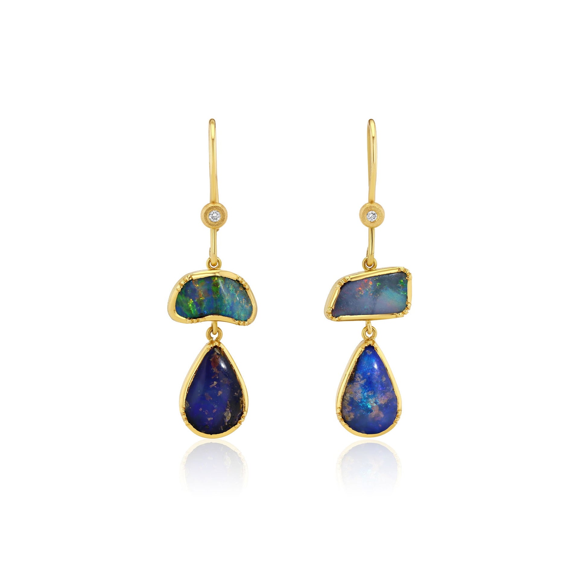 Gold earrings with blue opal gemstones on a white background