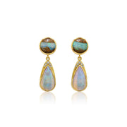 A pair of gold drop earrings featuring round cabochon opal stones at the top and teardrop-shaped opal drops below, accented with small clear stones, set against a plain white background.