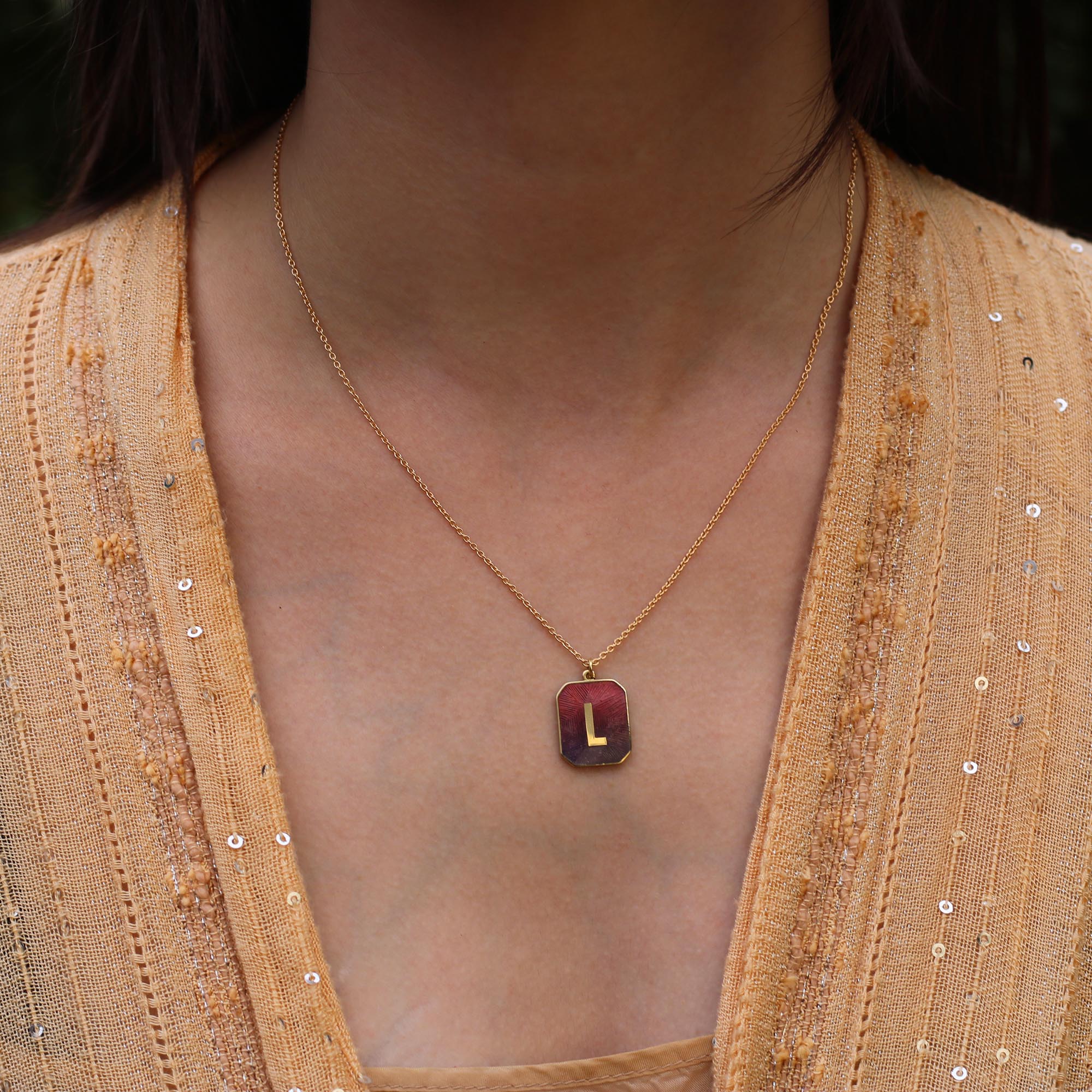 Model wearing Letter L, 18k gold Small Alphabet Sunset Enamel Letter Necklace by Los Angeles fine jewelry designer Brooke Gregson handmade in London
