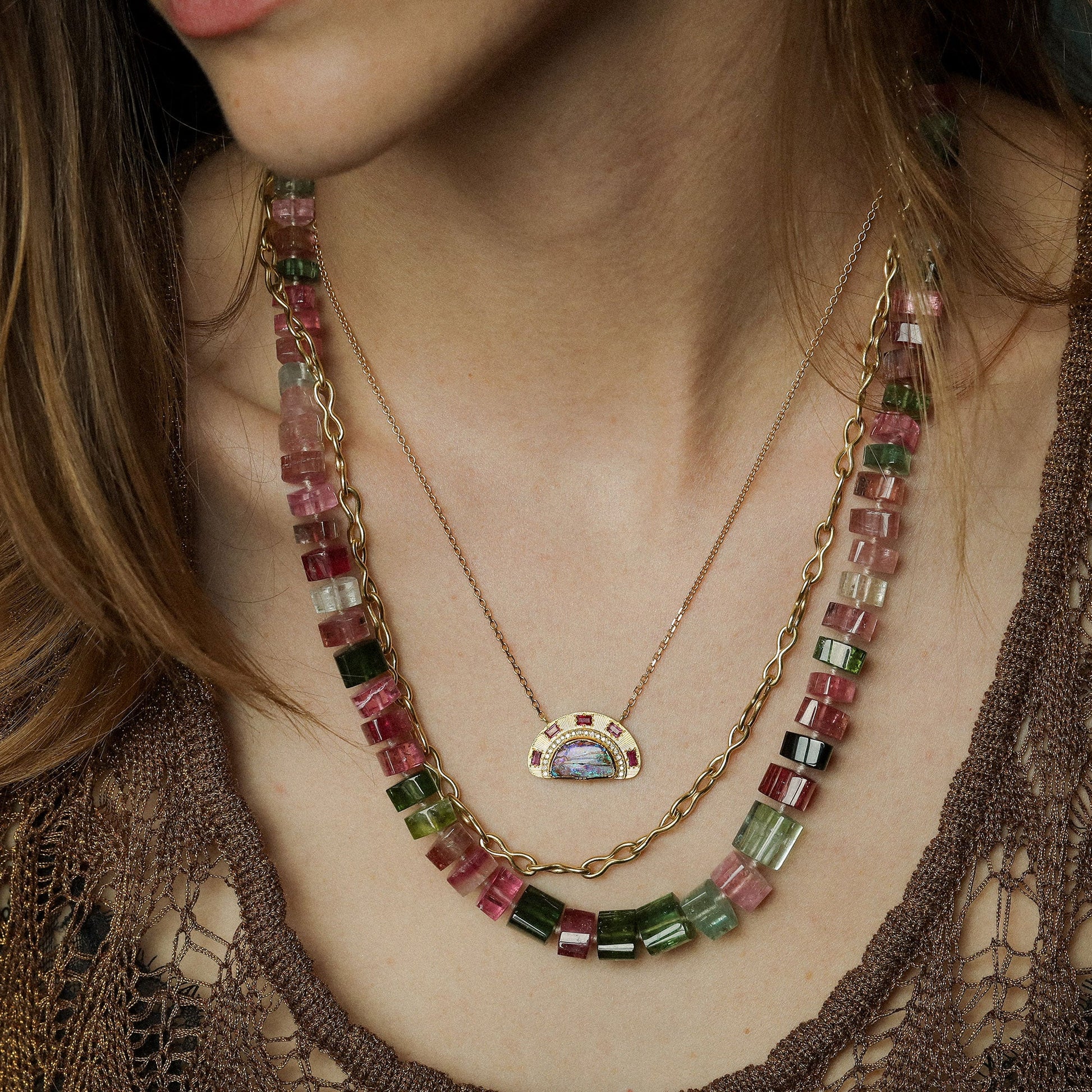 Close up of model wearing gem quality mixed color tourmaline bead necklace with 18k gold clasp from Los Angeles designer Brooke Gregson.