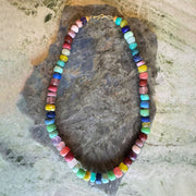 a colorful beaded necklace on a stone made by brooke gregson jewelry.