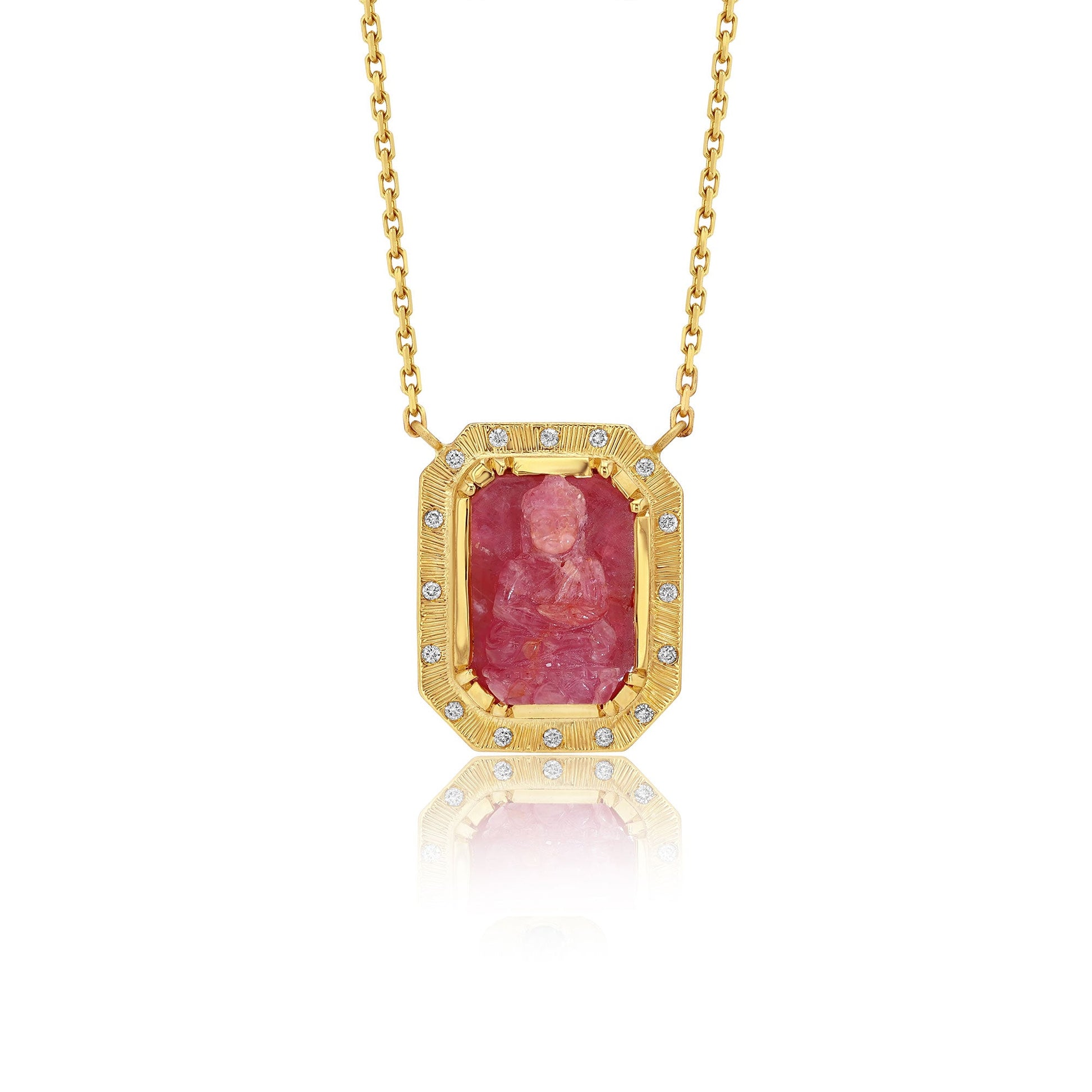 Gold necklace with a red ruby buddah gemstone pendant on a white background