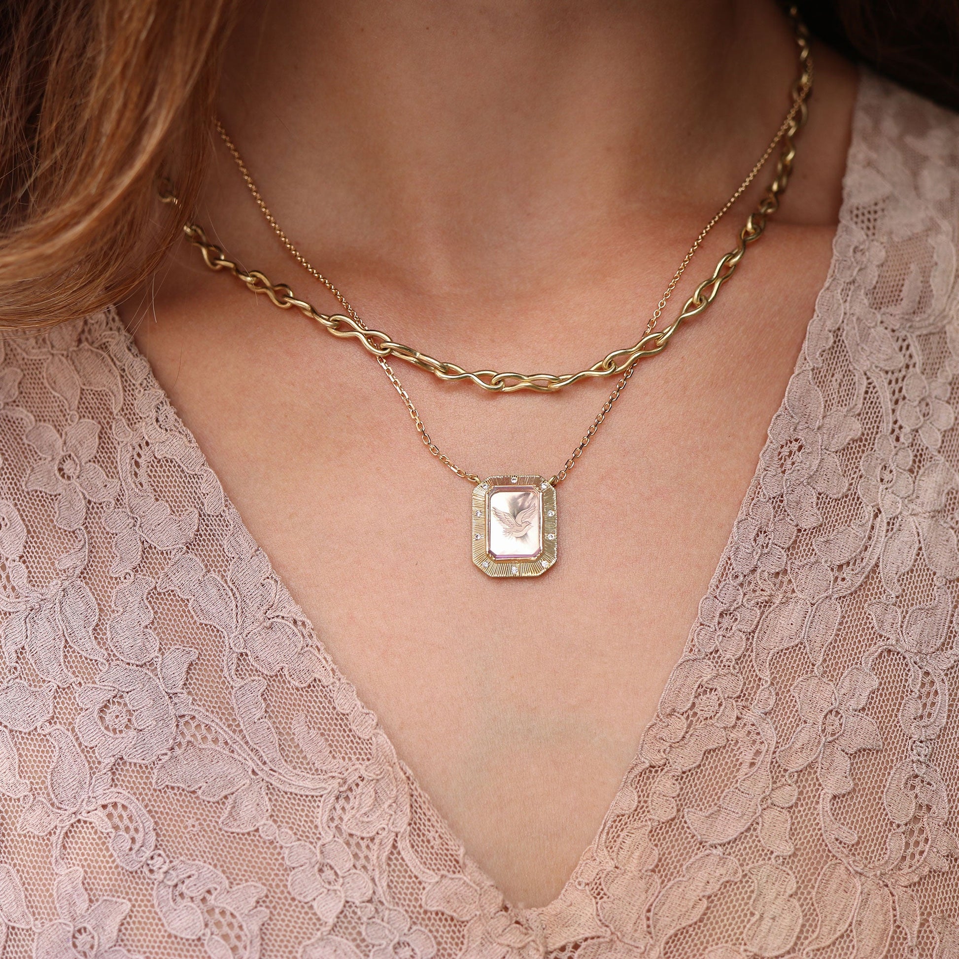 Model wearing One of a kind Amethyst bird necklace with Diamond pave 18k gold engraved fine jewelry handmade in London from Los Angeles designer Brooke Gregson.