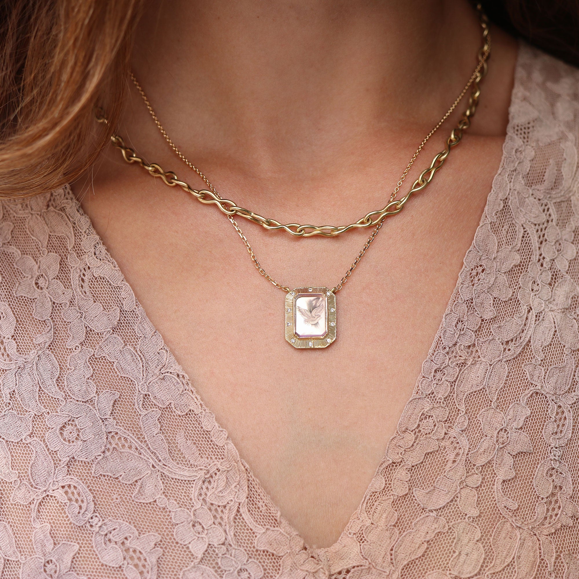 Model wearing One of a kind Amethyst bird necklace with Diamond pave 18k gold engraved fine jewelry handmade in London from Los Angeles designer Brooke Gregson.