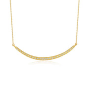 A delicate gold necklace featuring a curved bar pendant adorned with small, clear pavé-set stones, suspended from a fine gold chain against a solid white background.