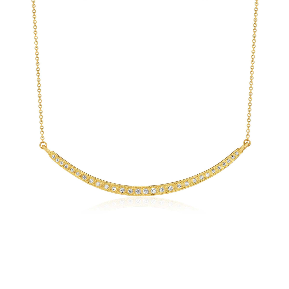 A delicate gold necklace featuring a curved bar pendant adorned with small, clear pavé-set stones, suspended from a fine gold chain against a solid white background.