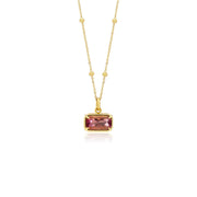 18K Gold necklace with a pink tourmaline gemstone pendant on a white background