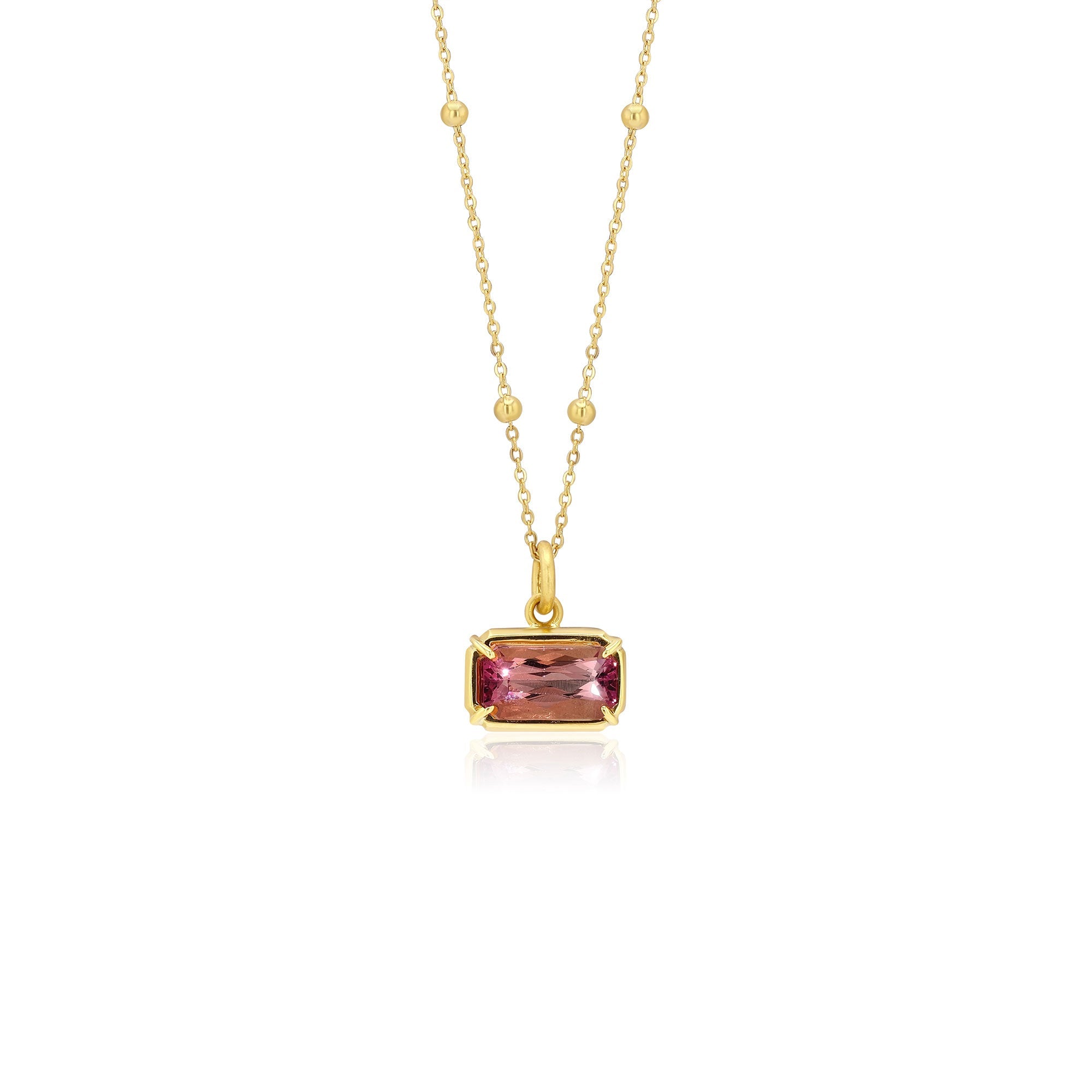 18K Gold necklace with a pink tourmaline gemstone pendant on a white background