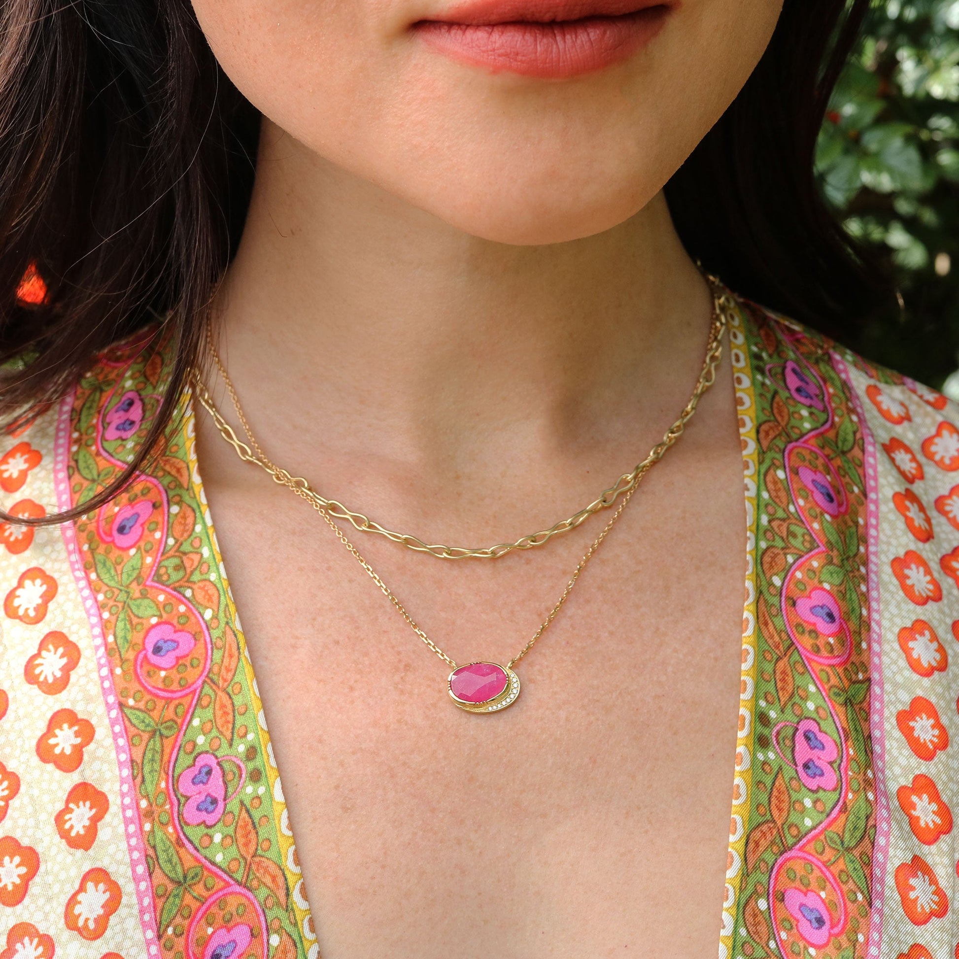 Girl wearing a ruby necklace with white diamond accents by Brooke Gregson.