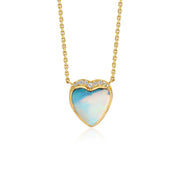 A gold heart pendant necklace featuring a light blue and white iridescent boulder opal center stone, accented with small diamond stones along the top curve, suspended from a delicate gold chain against a white background.