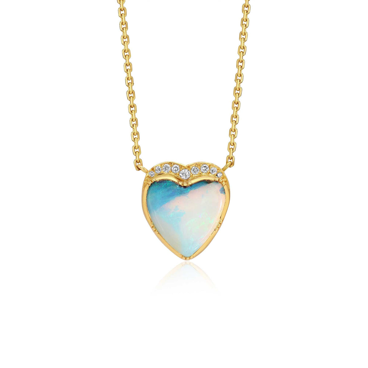 A gold heart pendant necklace featuring a light blue and white iridescent boulder opal center stone, accented with small diamond stones along the top curve, suspended from a delicate gold chain against a white background.