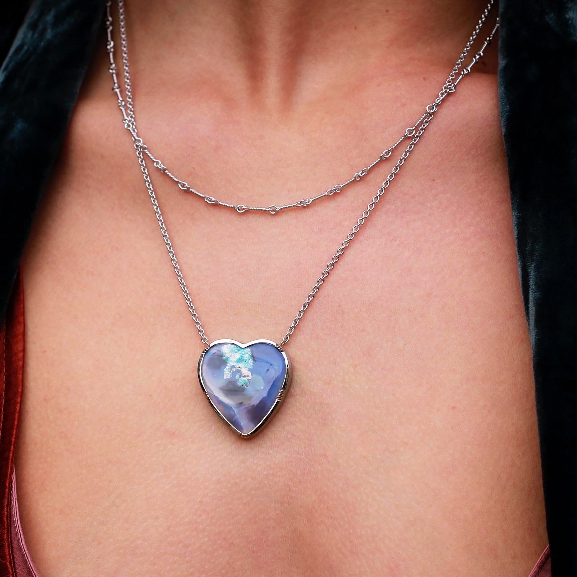 Model close up One of a kind 18k white gold heart shaped Wood Opal necklace. Fine jewelry hand made in London from Los Angeles designer Brooke Gregson.