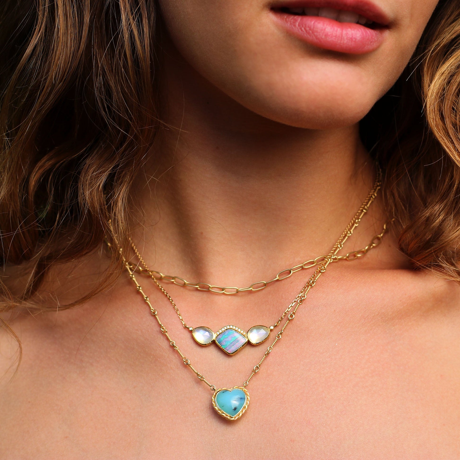 Model wearing One of a kind 18k gold heart shaped Peruvian Opal necklace with twisted gold frame and hand made chain inspired by the equestrian. Fine jewelry hand made in London from Los Angeles desginer Brooke Gregson.