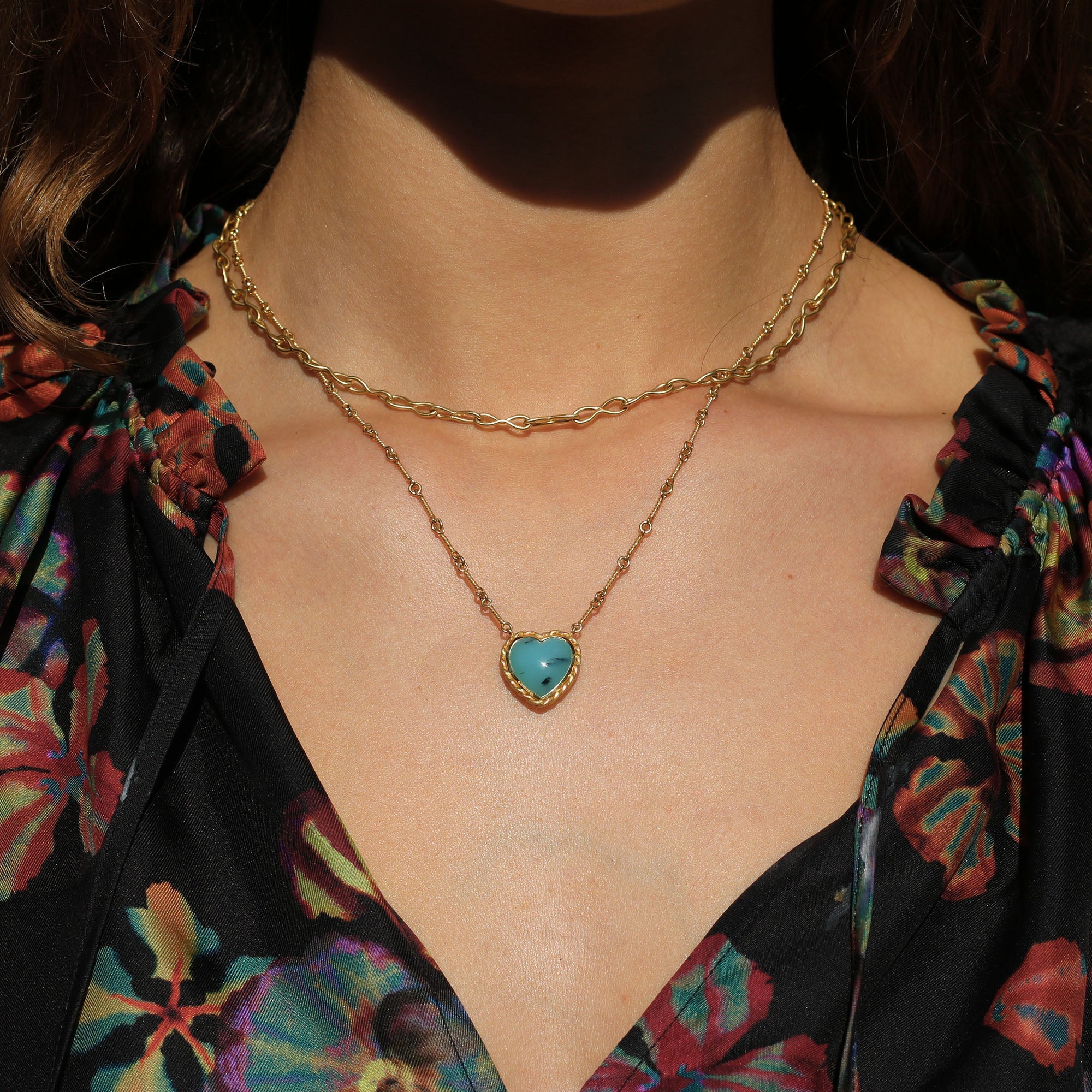 Model wearing One of a kind 18k gold heart shaped Peruvian Opal necklace with twisted gold frame and hand made chain inspired by the equestrian. Fine jewelry hand made in London from Los Angeles desginer Brooke Gregson.
