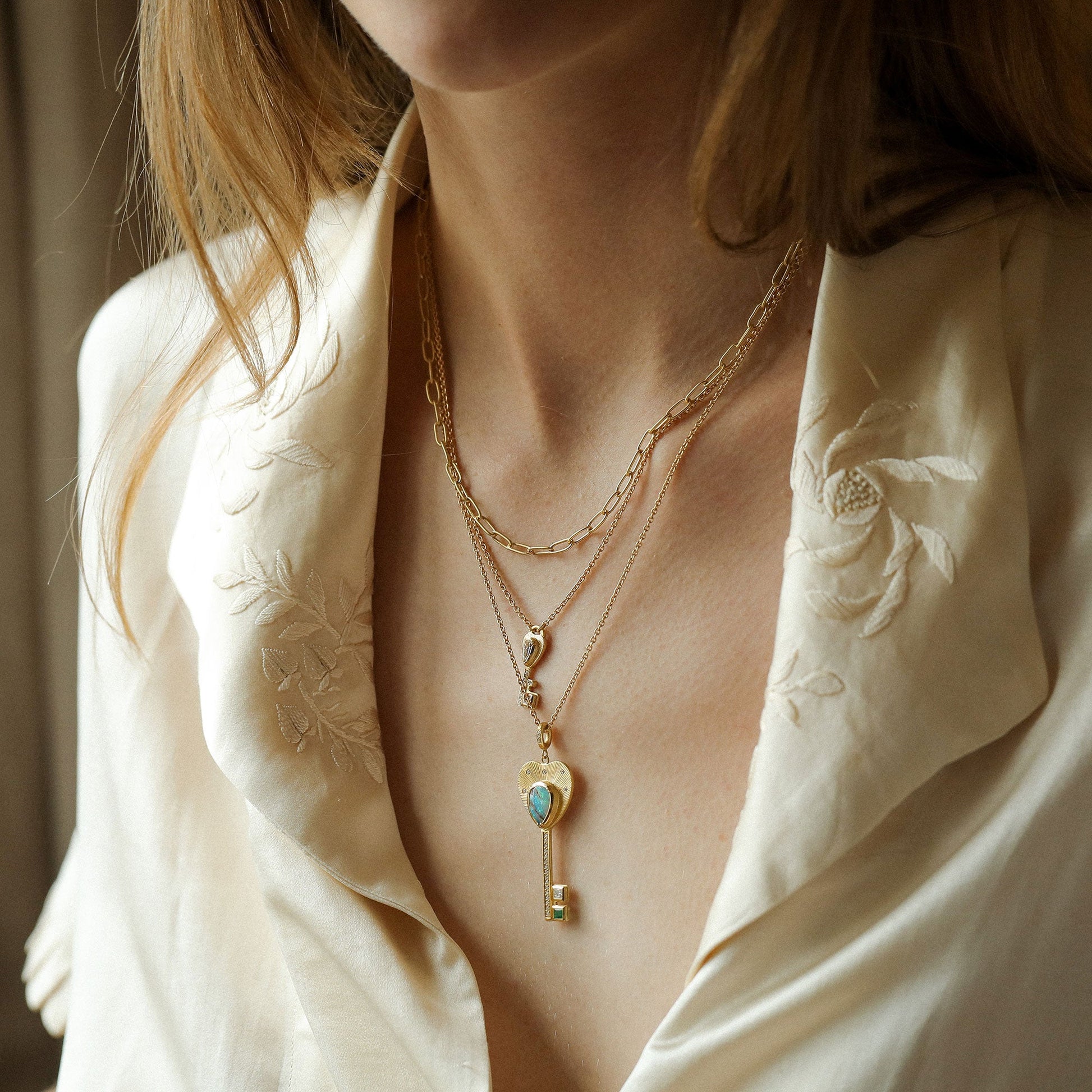 Model wearing one of a kind 18k gold diamond and opal key necklaces from Los Angeles jewelry designer Brooke Gregson.