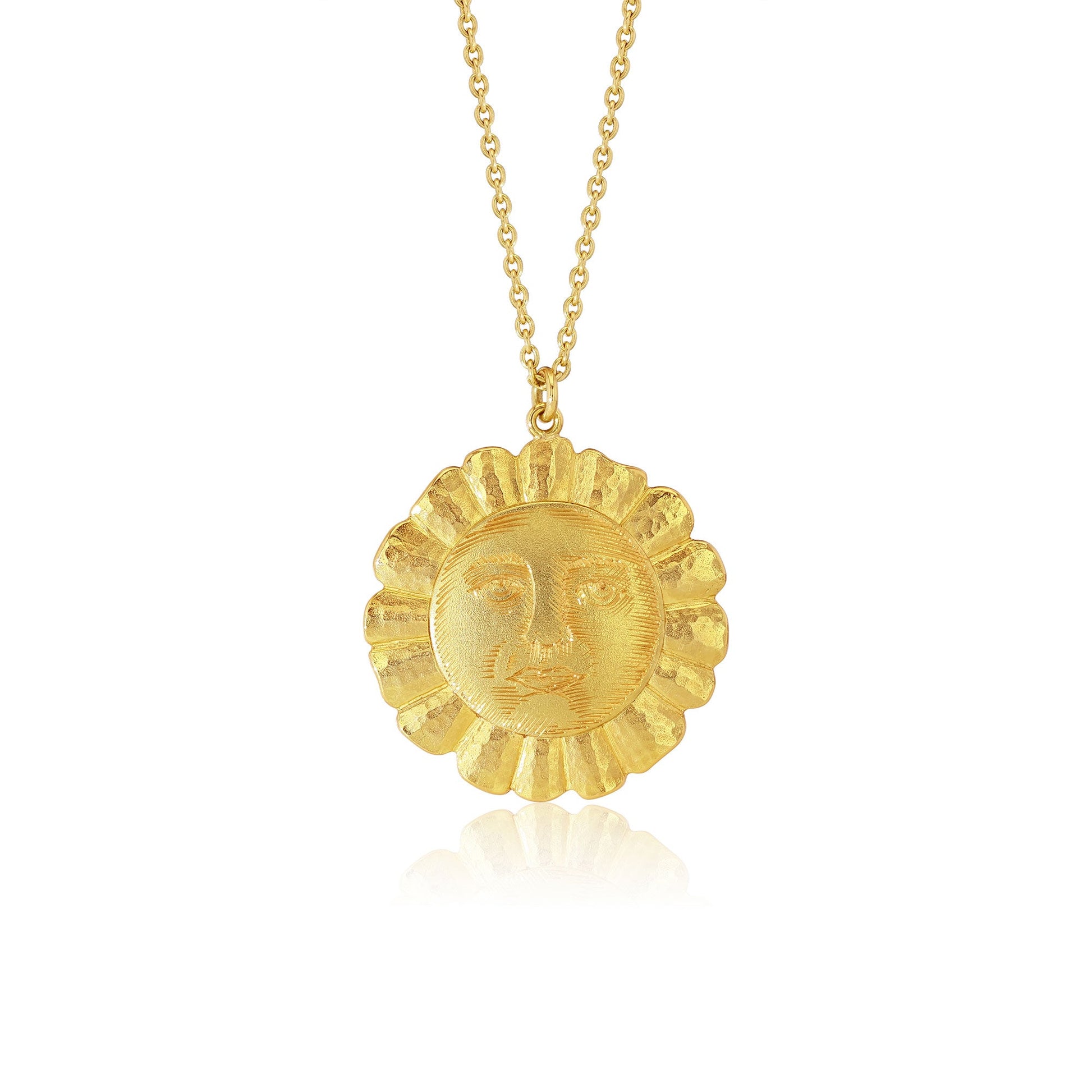 A textured gold pendant necklace featuring a sun face surrounded by radiating rays, suspended from a delicate gold chain against a clean white background.