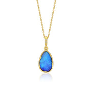 Gold necklace with a blue opal pendant on a white background