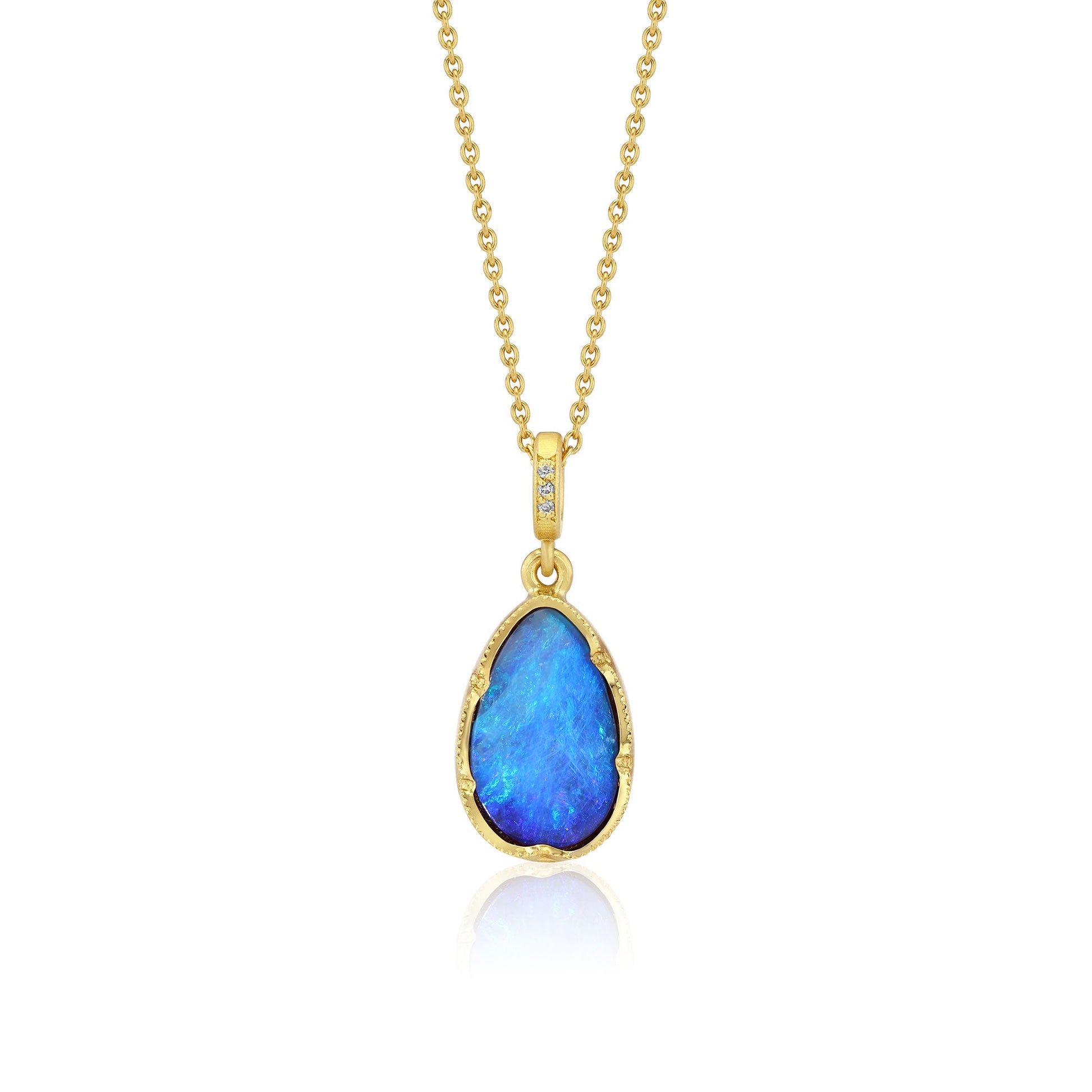 Gold necklace with a blue opal pendant on a white background