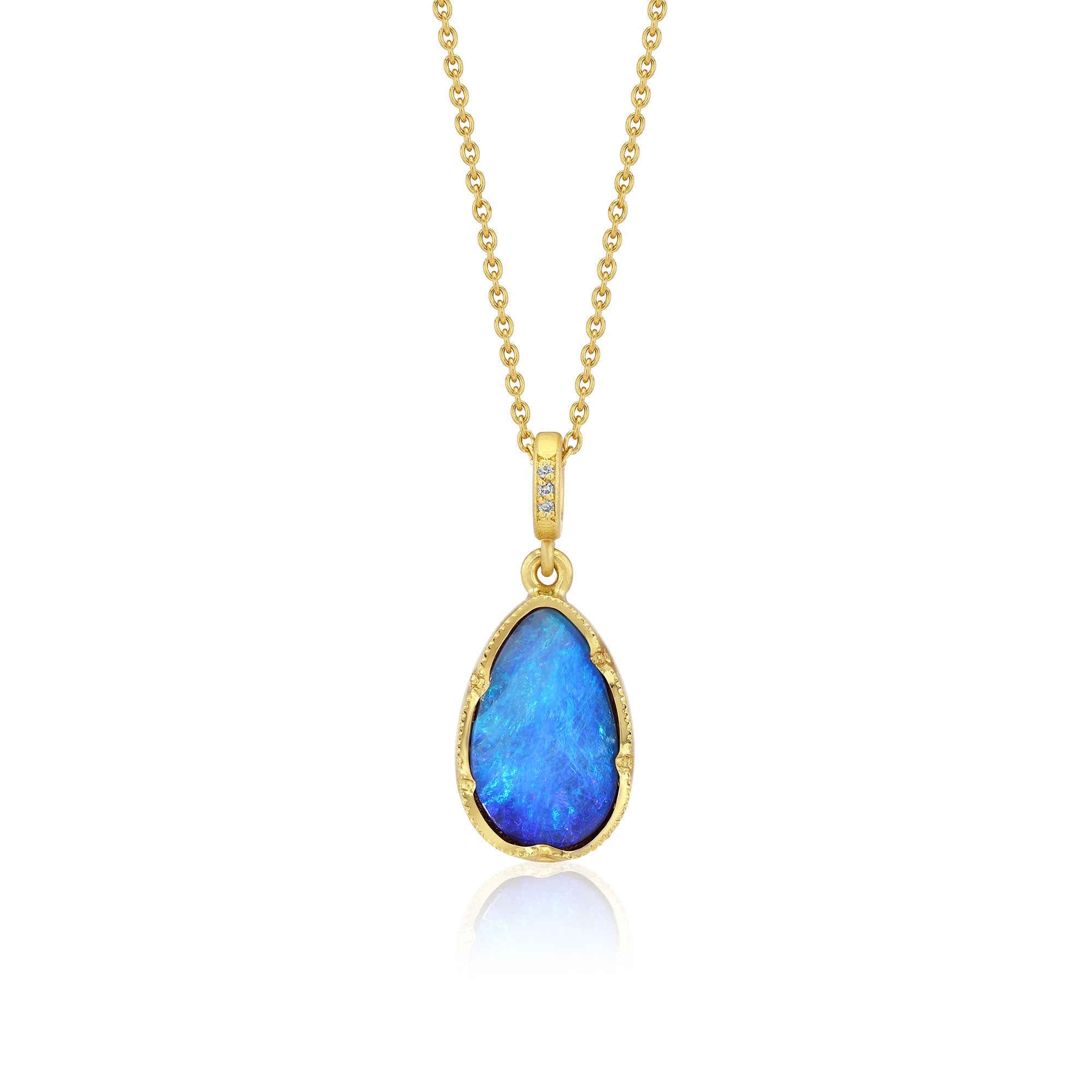 Gold necklace with a blue opal pendant on a white background