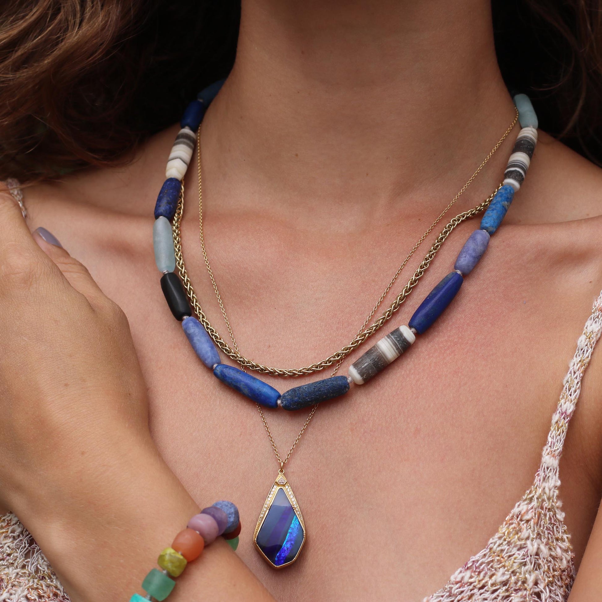 Model wearing One of a kind 18k gold Boulder Opal necklace with white diamond highlights. Fine jewelry hand made in London.