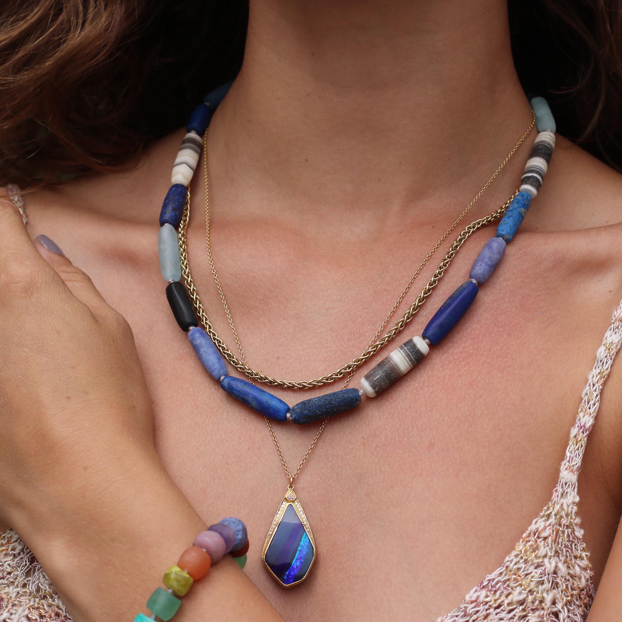 Model wearing One of a kind 18k gold Boulder Opal necklace with white diamond highlights. Fine jewelry hand made in London.