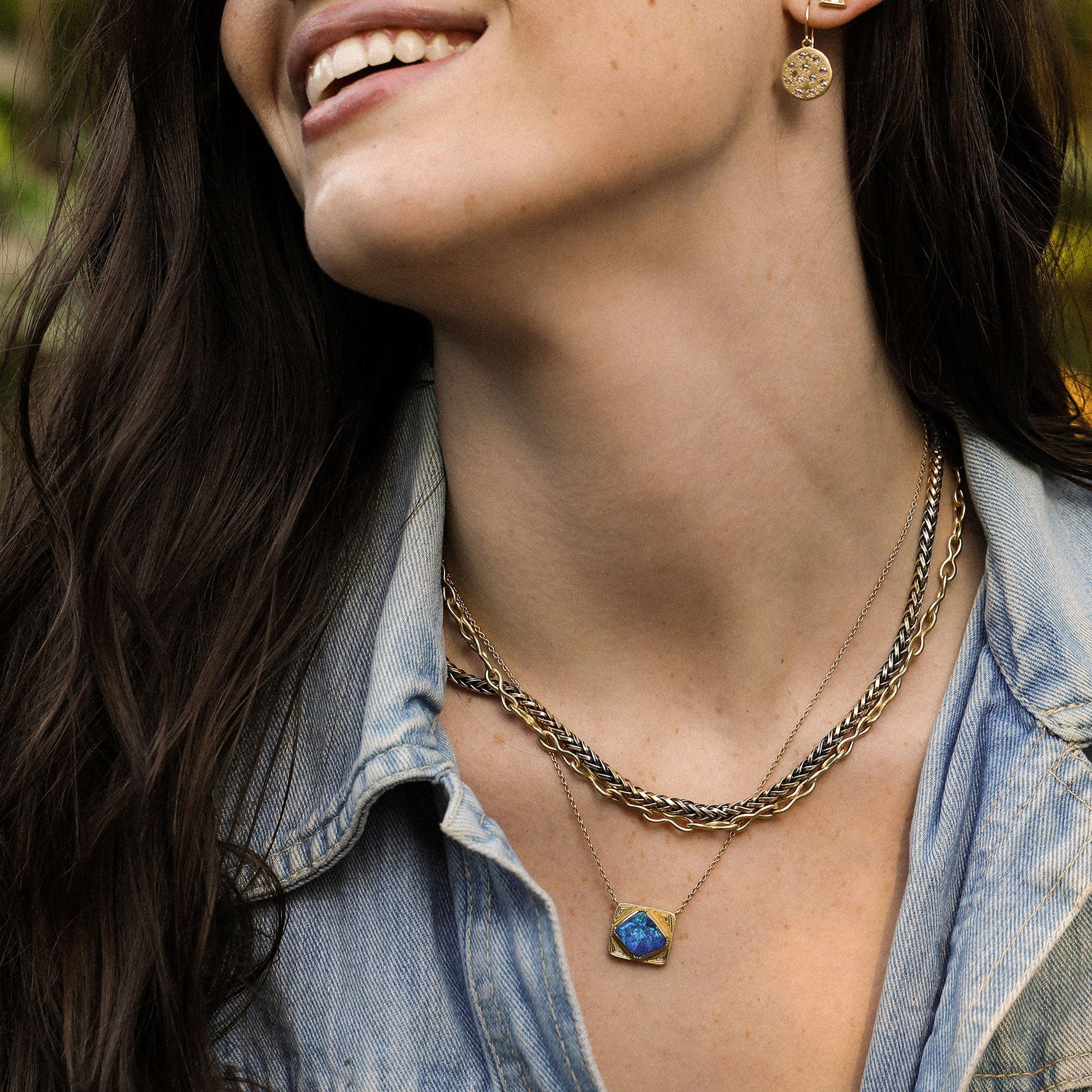 Model wearing Handmade 18k gold Boulder Opal necklace with hand engraving. Fine jewelry hand made in London from Los Angeles designer Brooke Gregson.