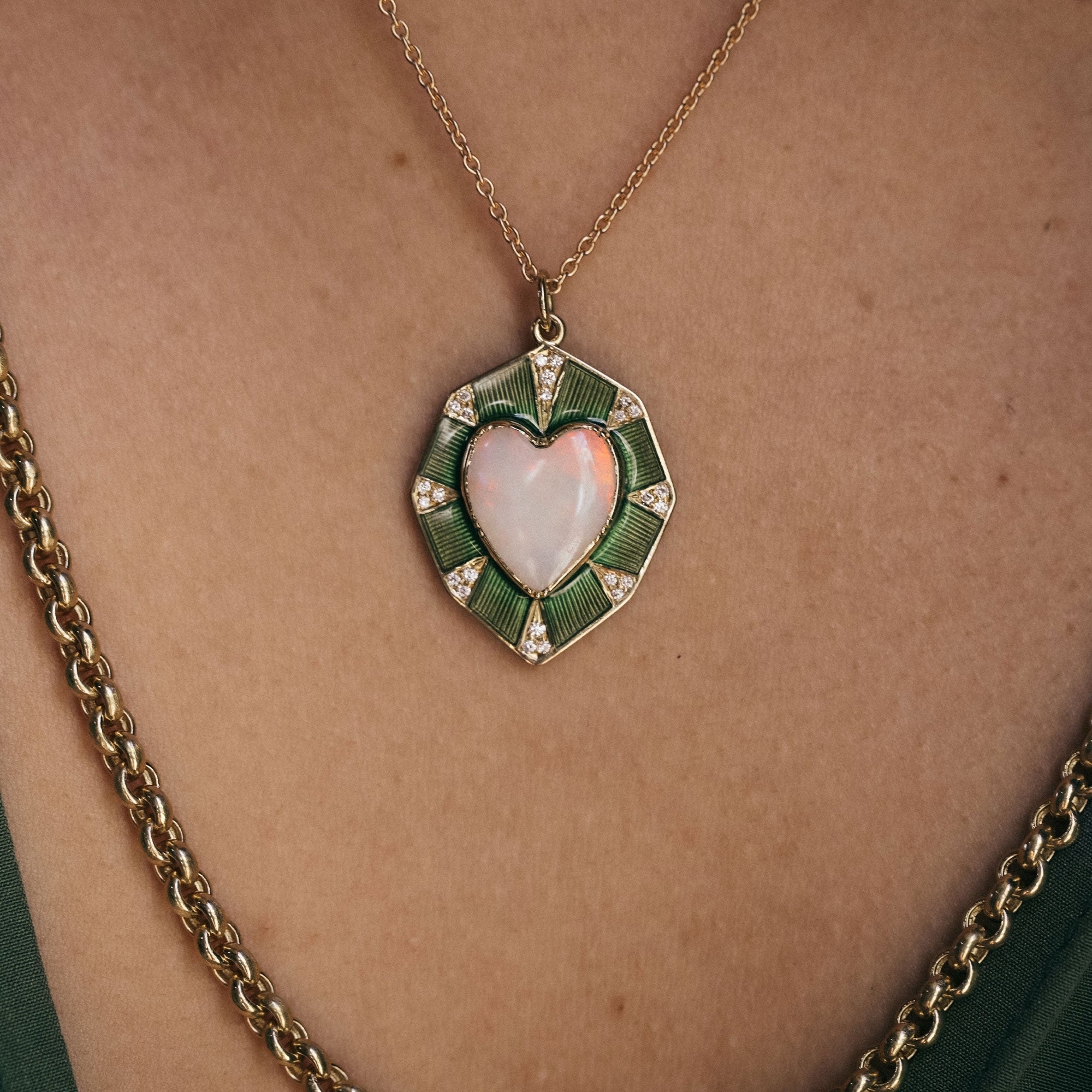 Gold necklace with a heart-shaped pendant on a person's neck