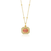 Gold pendant with a central rhodochrosite gemstone with white diamond pave detailing on a white background
