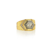 18k gold ring with a large hexagonal raw diamond gemstone and smaller stones on a white background.
